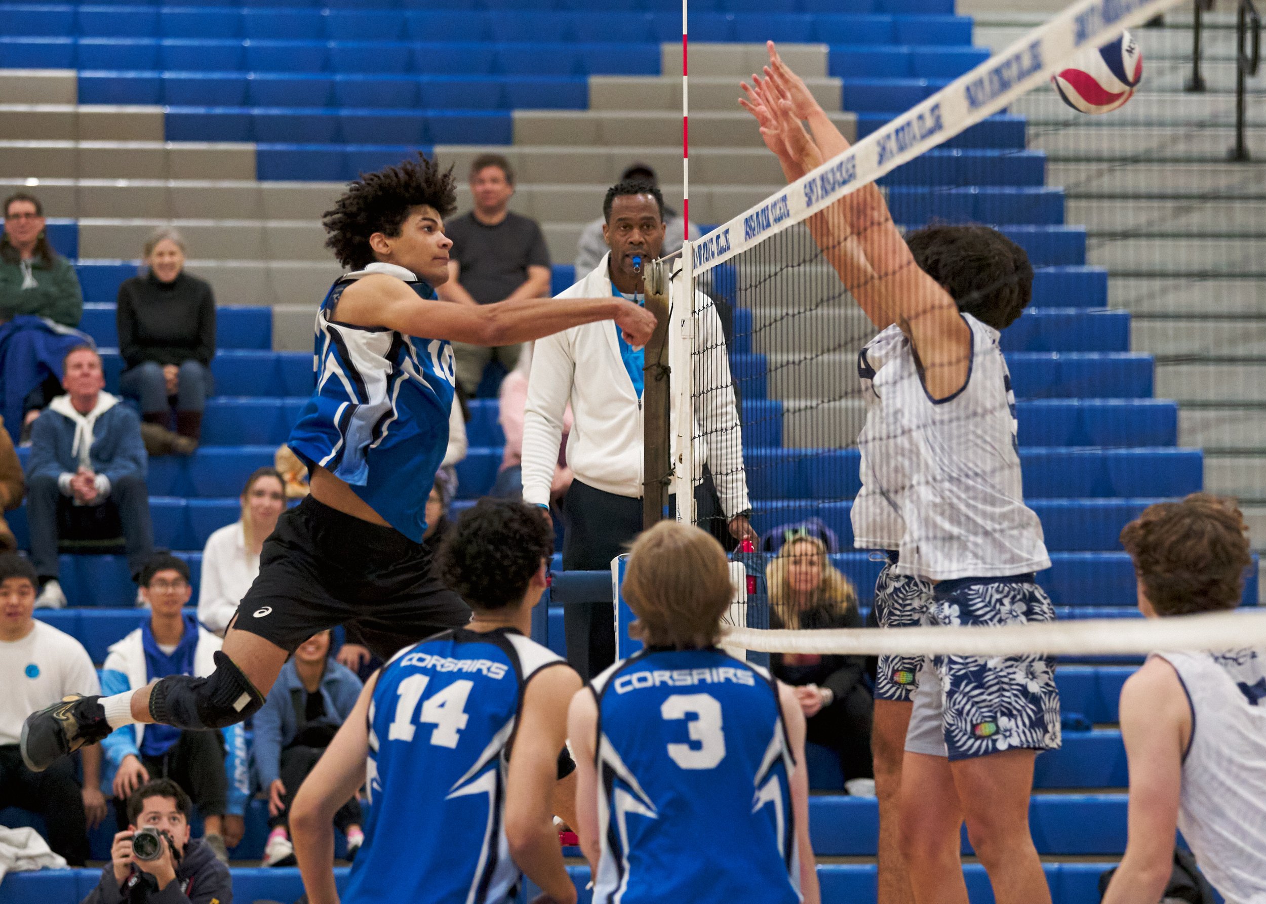  Santa Monica College Corsairs' Nate Davis sends the ball past Irvine Valley College Lasers' Julio Gutierrez (right) and Kaina Alvarez (rear right) during the men's volleyball match on Friday, Feb. 24, 2023, at Corsair Gym in Santa Monica, Calif. The