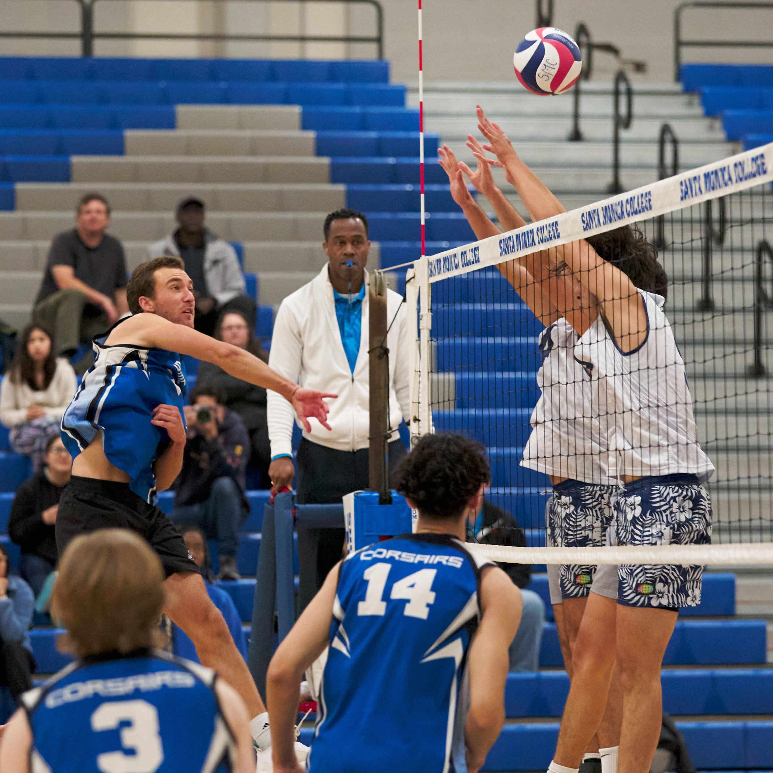  Santa Monica College Corsairs' Kane Schwengel sends the ball past Irvine Valley College Lasers' Julio Gutierrez (right) and Kaina Alvarez (rear right) during the men's volleyball match on Friday, Feb. 24, 2023, at Corsair Gym in Santa Monica, Calif.