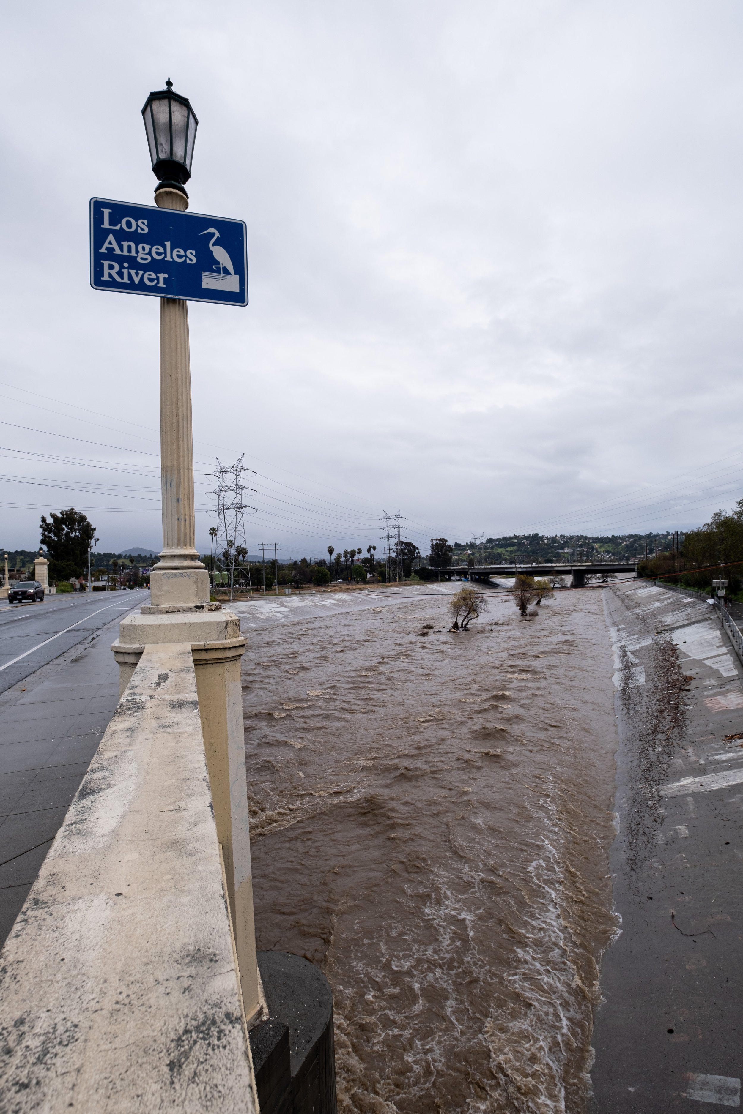  The Los Angeles River fills with water as heavy winter storms have poured down on the streets of Los Angeles, Calif. Seen from Fletcher Drive on Saturday February 25, 2023, the brown water surges through the concrete banks. (Akemi Rico | The Corsair