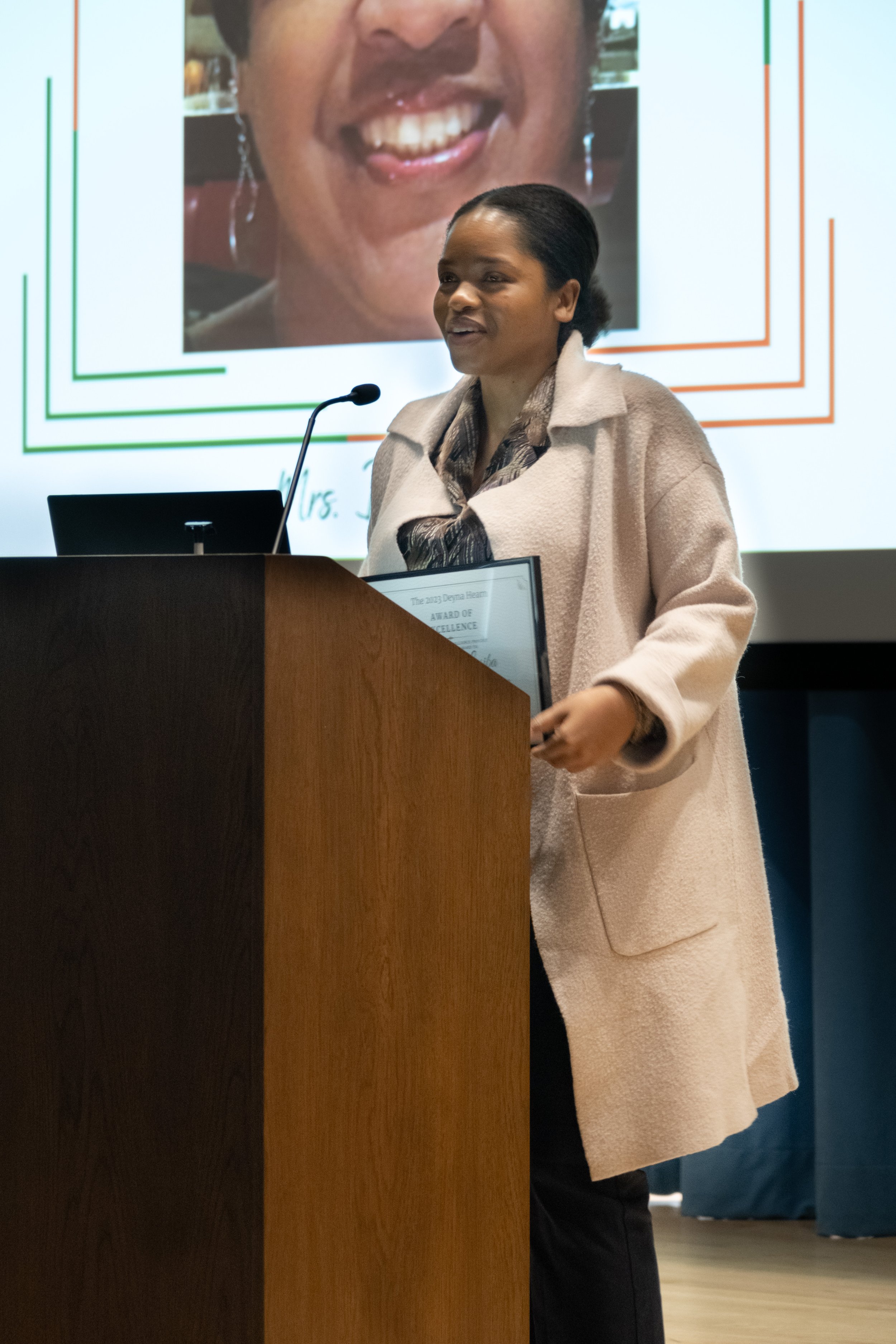  Santa Monica College student Lorrancia Lusiba, winner of the 2023 Deyna Hearn Student Award of Excellence, accepting her award onstage at the Orientation Hall in Santa Monica College's (SMC) Student Services Center, on Friday, February 24, 2023. (Ak