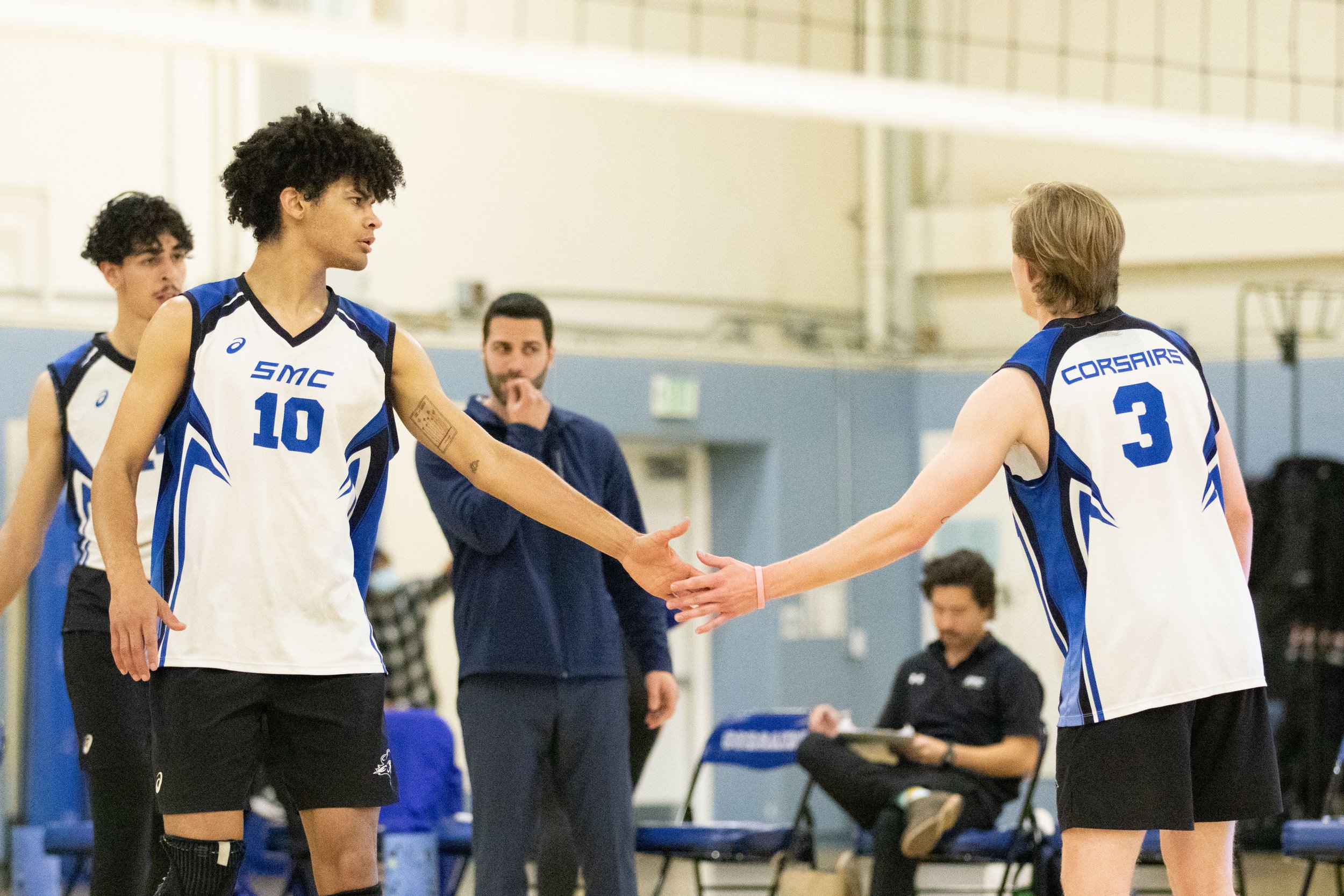  Santa Monica College Corsair outside hitter Nate Davis (10, left) and setter Camden Higbee (3, right) celebrating scoring a point during the first set of a home game in Santa Monica, Calif., on Friday, March 3, 2023. The game resulted in the Corsair