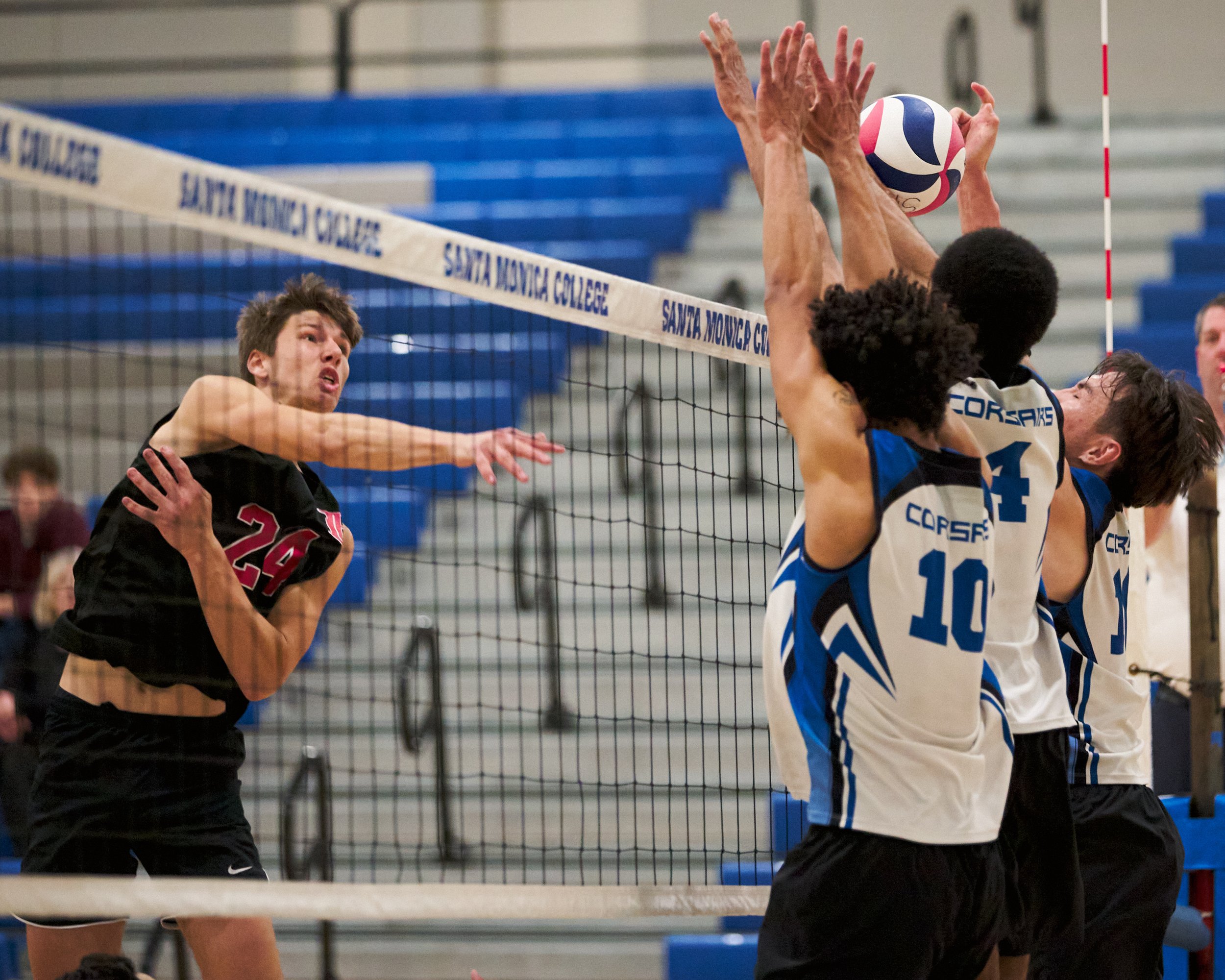  Long Beach City College Vikings' Cole Oliver hits the ball past Santa Monica College Corsairs' Nate Davis, Beikwaw Yankey, and Enkhtur Tserendavaa during the men's volleyball match on Friday, March 4, 2023, at Corsair Gym in Santa Monica, Calif. The