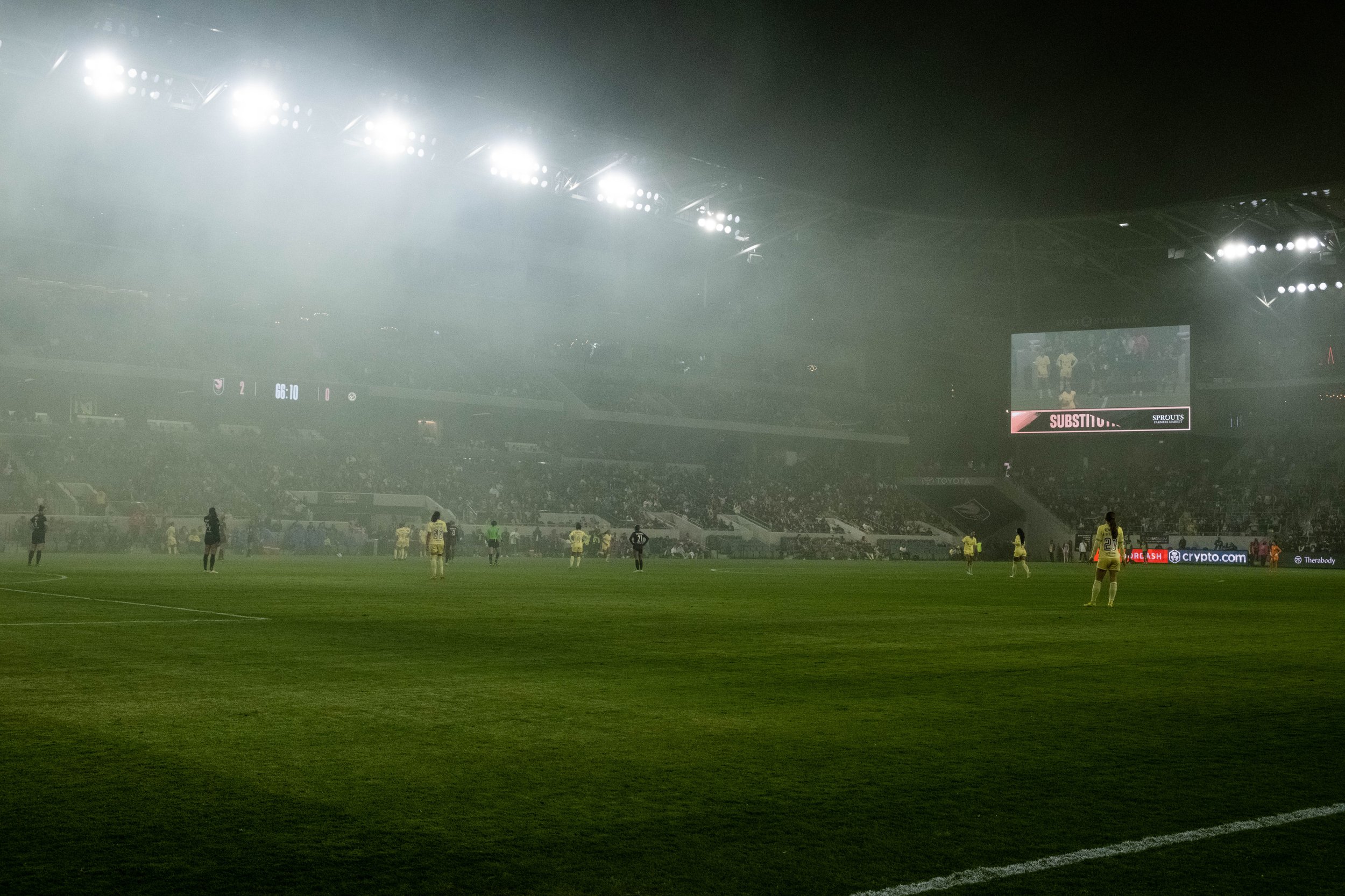  Angel City Football Club and Club America Femenil waiting to resume the game as subtitutes are being brought in for players while the yellow smoke realeased from fans that covered the field was slowly disapearing during their international friendly 