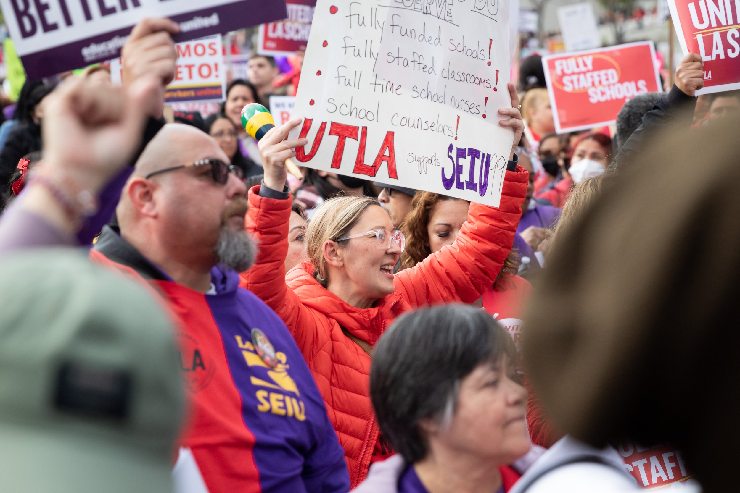  A protester holding a sign that has a list of demands at a joint rally held by United Teachers Los Angeles (UTLA) and Service Workers International Union (SEIU) Local 99 outside Los Angeles City Hall, Los Angeles, Calif., on Wednesday, March 15, 202