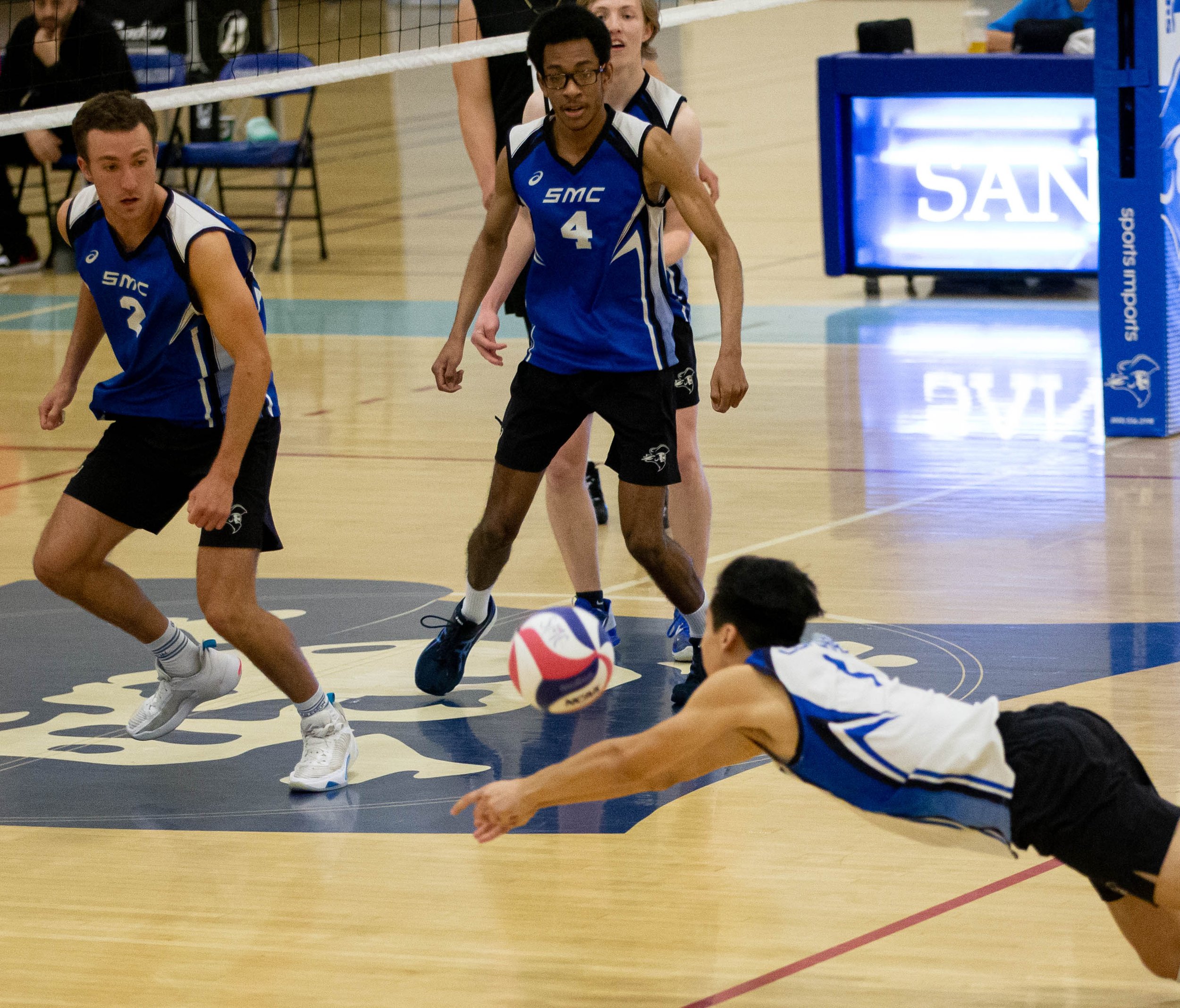  Santa monica College(SMC) Corsairs libero Javier Castillo(7) diving for the ball as Kane Schwengel(2) and Beikwaw Yankey(4) prepare to set to ball to be hit towards L.A. Pierce Colleges side of the court on Wed. March 15, 2023 in the SMC Pavillion a