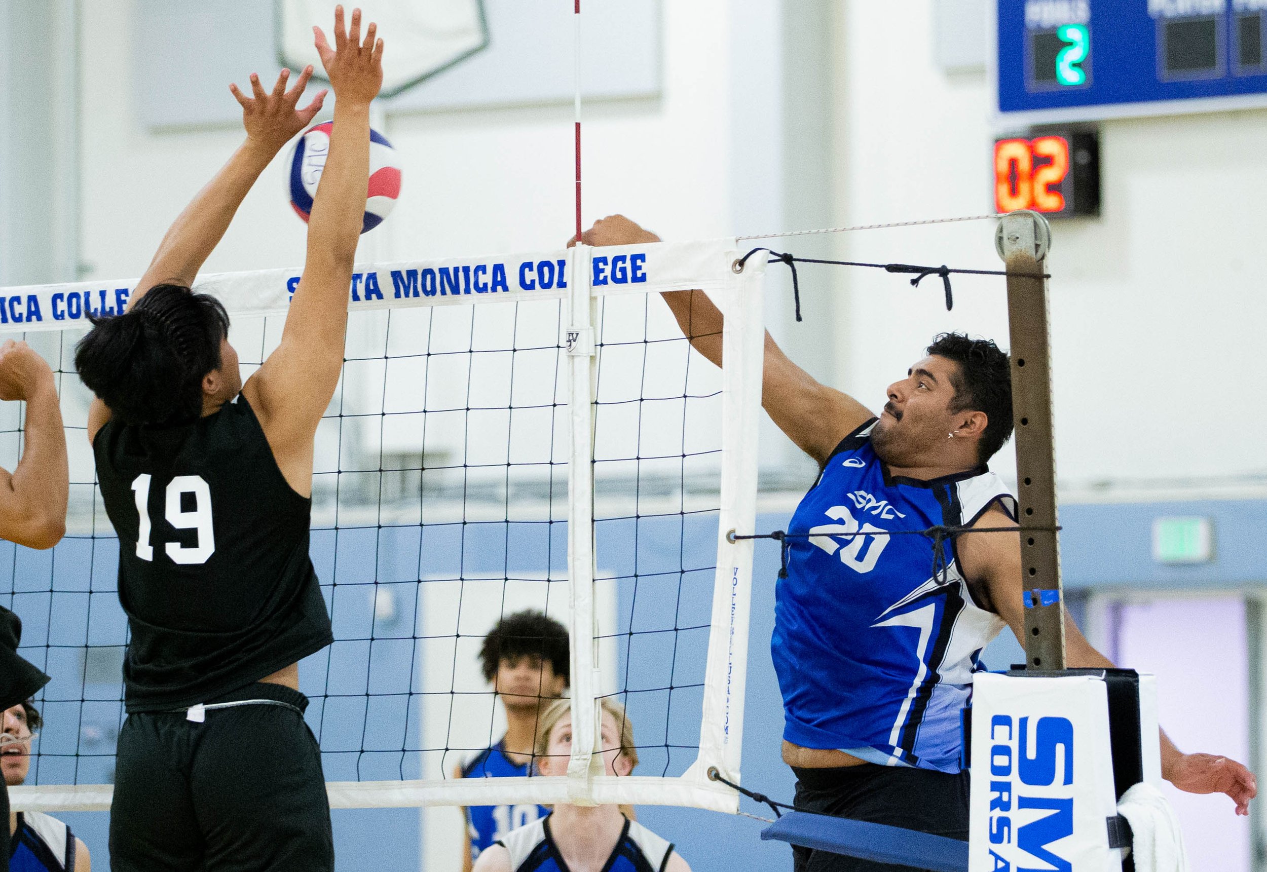  Santa Monica College(SMC) Corsairs outside hitter Sergio Carrera(20) hitting the ball over to L.A. Pierce College Brahma Bulls side as Josh Berina(19) goes for the block during their match on Wed. March 15, 2023 in the SMC Pavillion at Santa Monica,