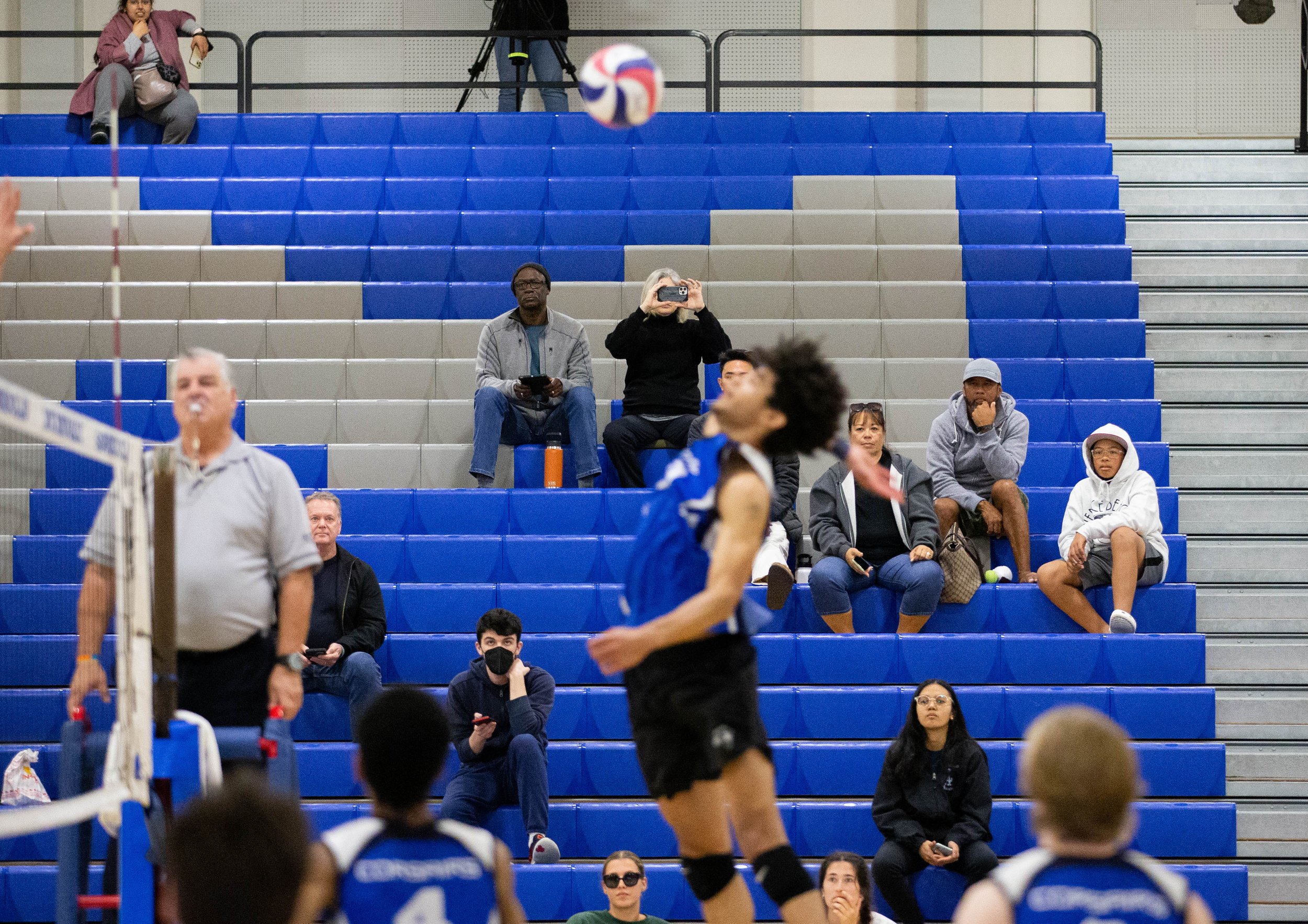  Attendees of the men's volleyball game between the Santa Monica College(SMC) Corsairs and L.A. Pierce College Brahma BUll watching Nate Davis(10) jump for a "kill" to end the game with the Corsairs taking the win on Wed. March 15, 2023 in the SMC Pa
