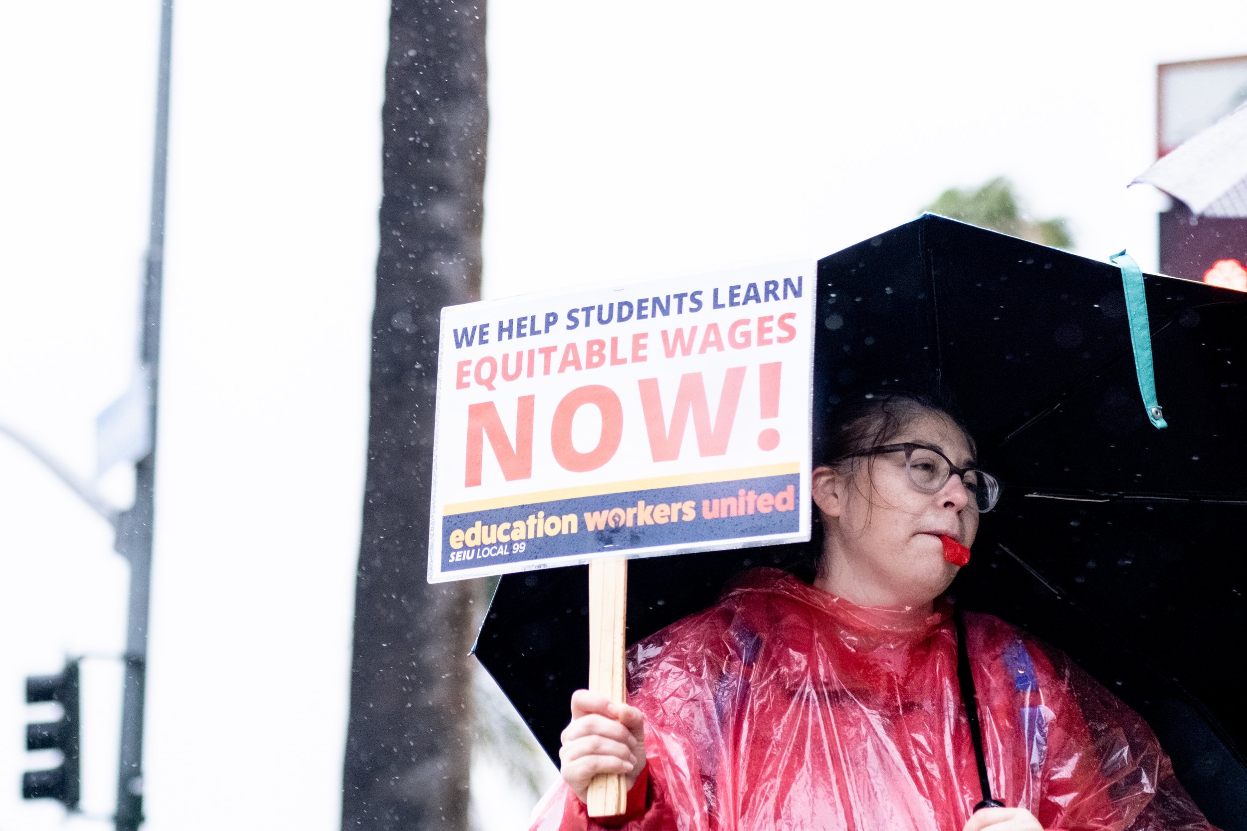  A protester holds a sign and blows a whistle while supporting Los Angeles Unified School District staff in front of Hollywood High School, in Los Angeles, Calif. on Tuesday, March 21, 2023. (Akemi Rico | The Corsair) 