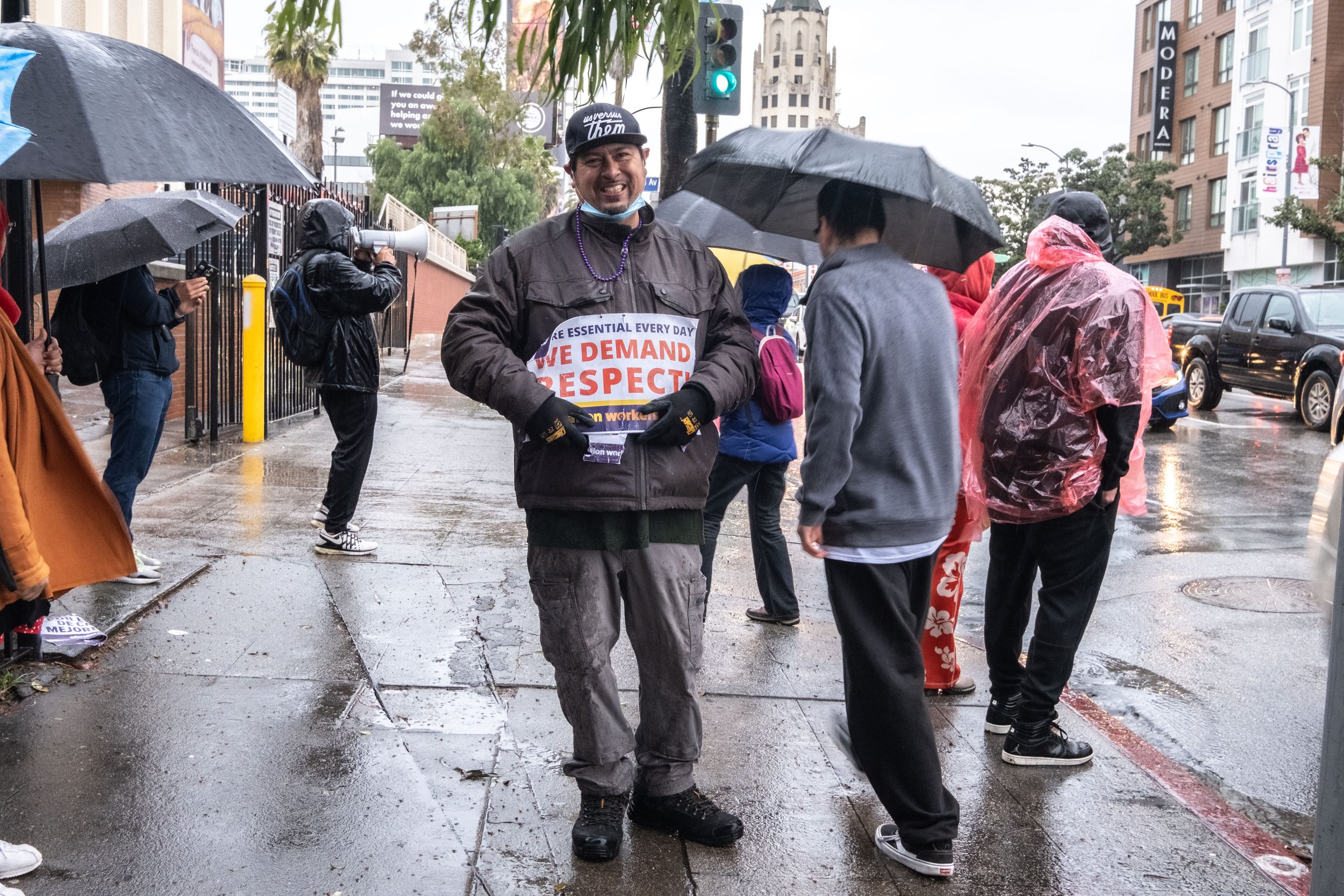  Luis Granados is a custodian at Hollywood High School in Los Angeles, Calif. He states, "We feel that we're not getting our fair share of pay, I think we deserve more, because right now we're short on staff, short on custodians."He stands with a sig