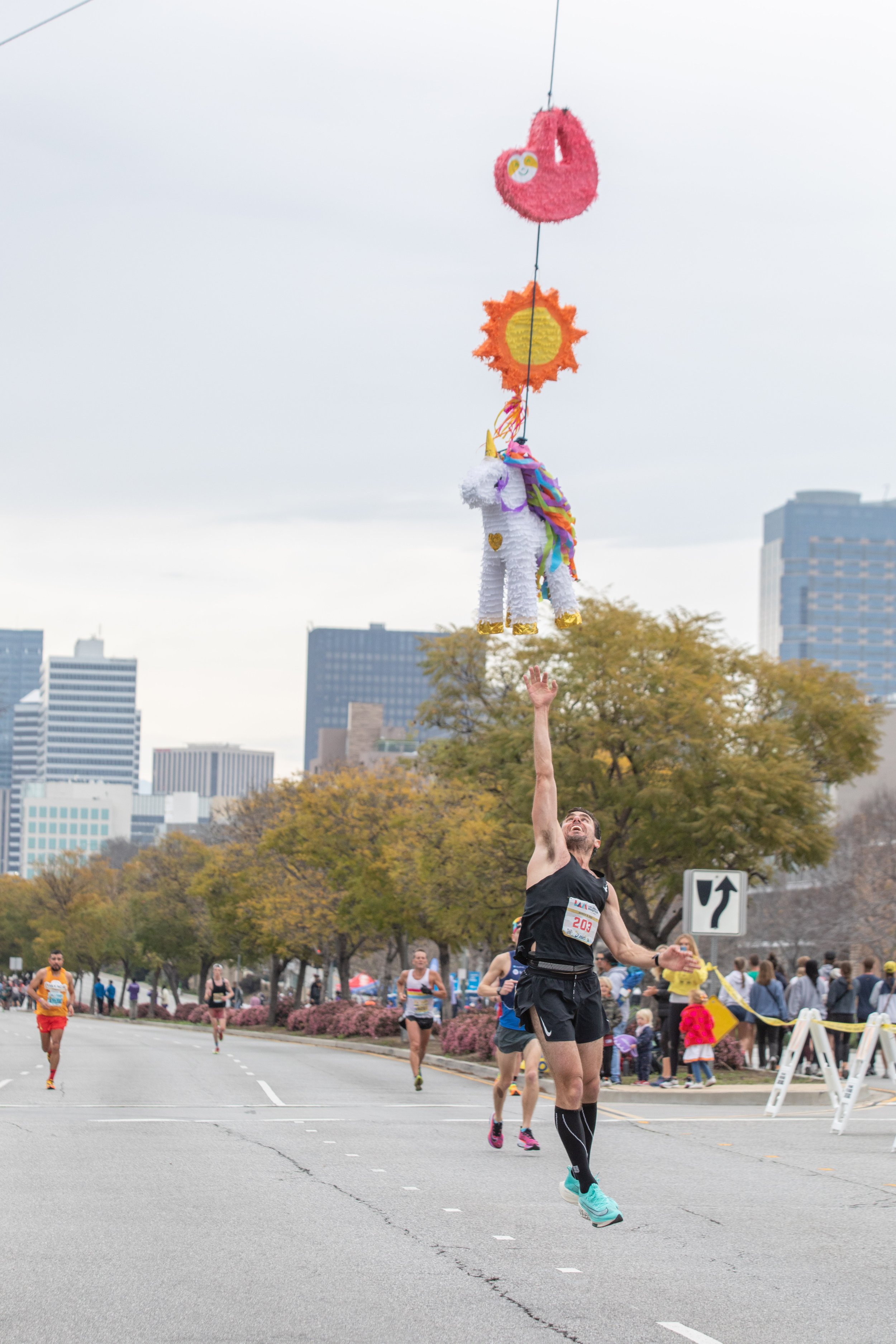  Shant Hagopian from Glendale, California jumps to touch the piñata at mile 19. Hagopian finished 38th place overall on Sunday, March 19, 2023. Los Angeles, Calif. (Jorge Devotto | The Corsair) 