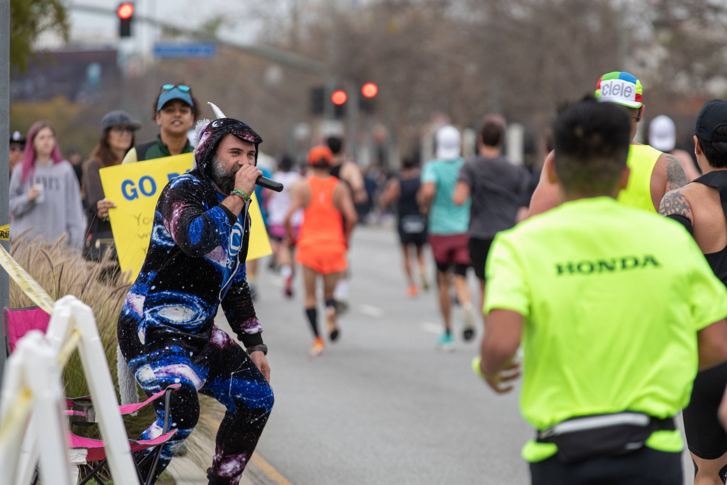  Javier García on a unicorn outfit and a microphone encouraging the runners heading West on Santa Monica Blvd. with cheers and funny comments during the L.A. Marathon 2023. García belongs to the Cruda running club, but they joined forces with Valley 