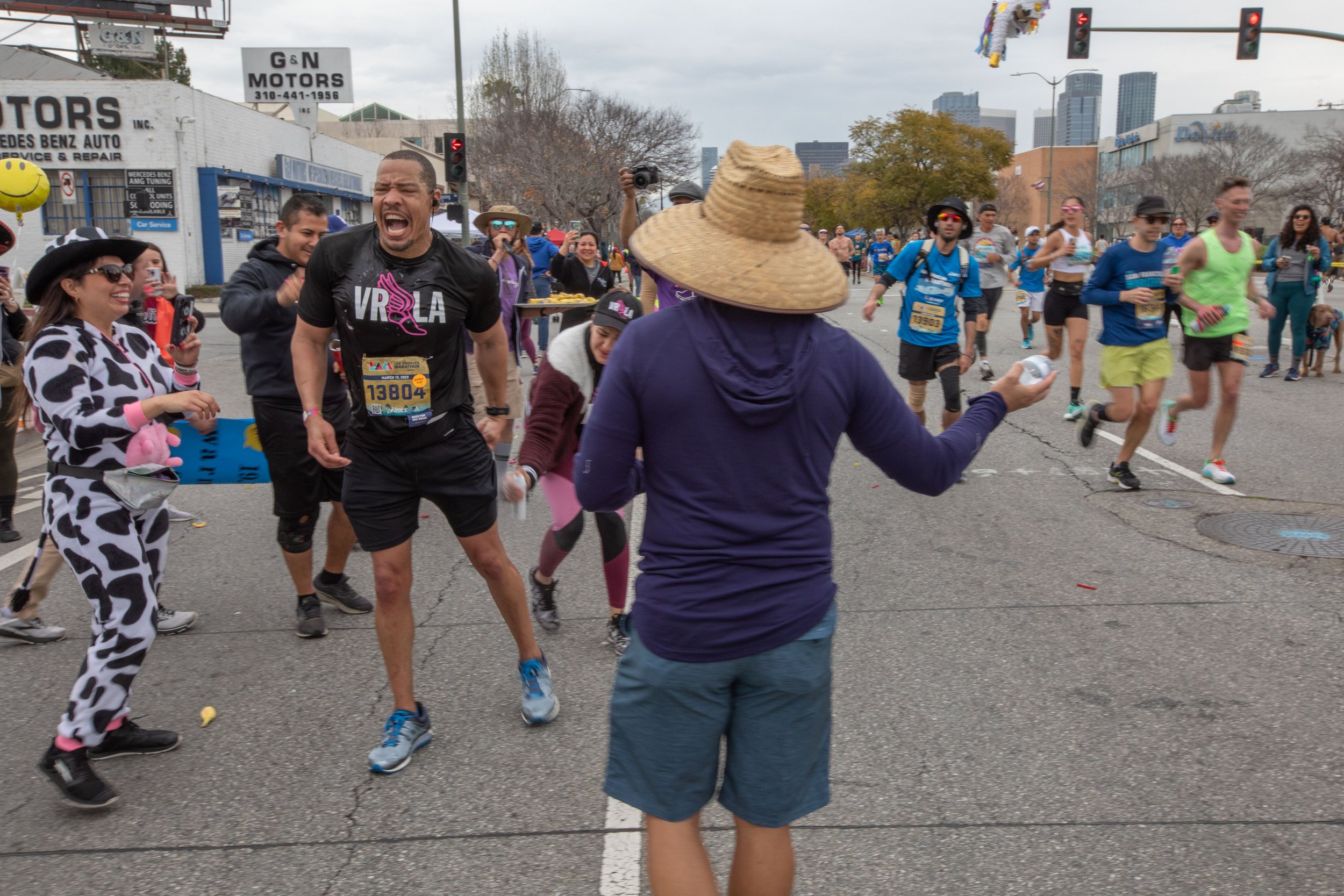  Valley Runners Los Angeles member Anthony Hartzog makes it to mile 19 where his club cheers him up. At the same time Hartzog requires helps with a cramp from the cheering station during the 38th Annual L.A. Marathon 2023. Sunday, March 19, 2023. Los