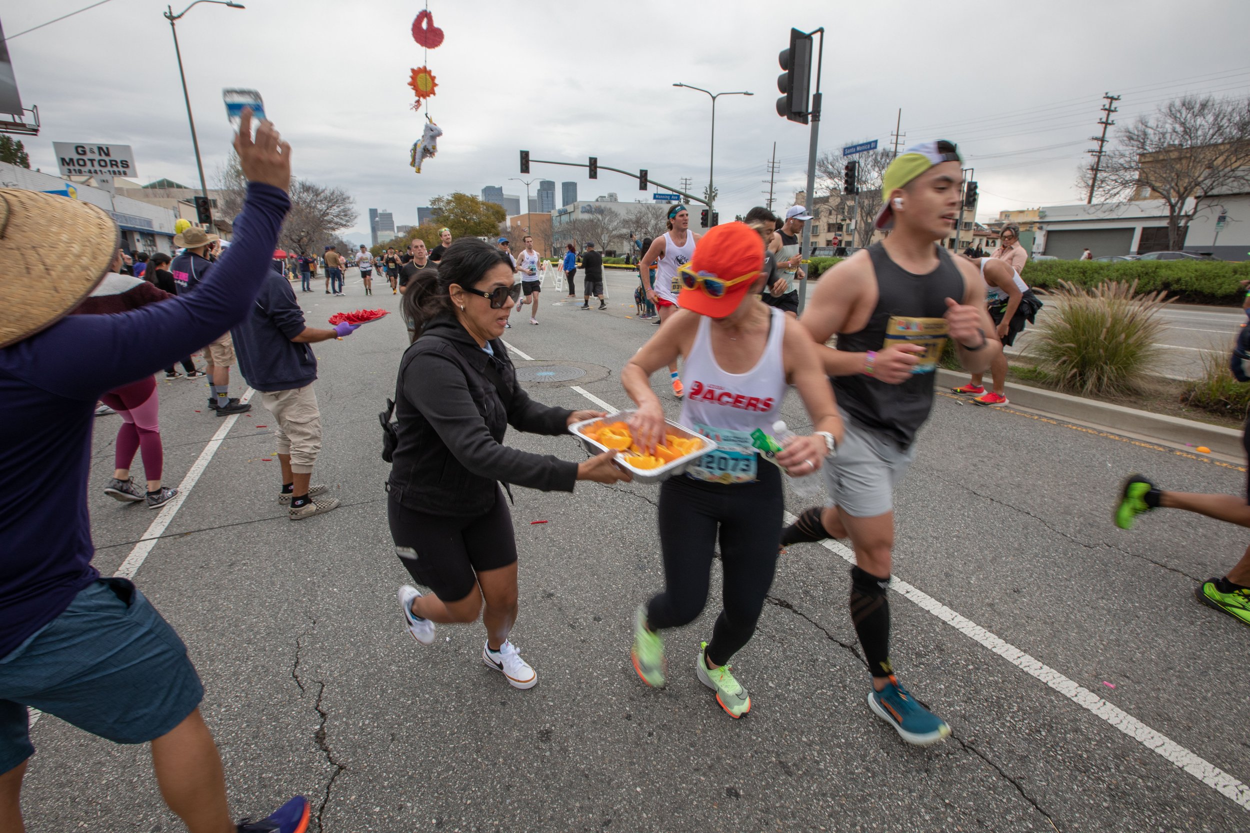  Valley Runners Los Angeles members help participants with cheers, orange slices, red vines, and water on mile 19 during the 38th Annual L.A. Marathon 2023. Sunday, March 19, 2023. Los Angeles, Calif. (Jorge Devotto | The Corsair) 