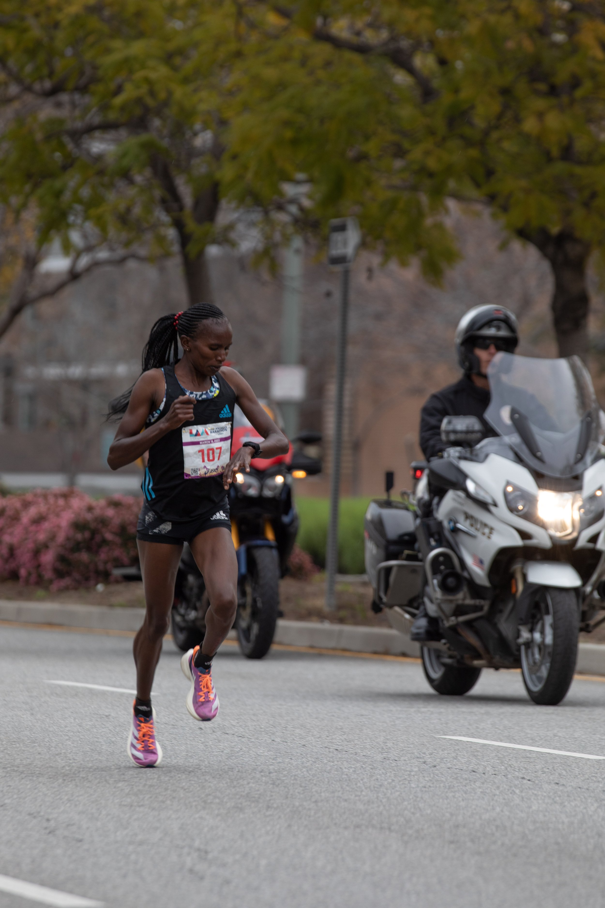  Stacy Ndiwa from Kenya check her watch running on Santa Monica Blvd. heading West to the mile 19 during the L.A. Marathon 2023. Ndiwa won the female competition with a time of 2 hours, 31 minutes, 01 seconds. Sunday, March 19, 2023. Los Angeles, Cal