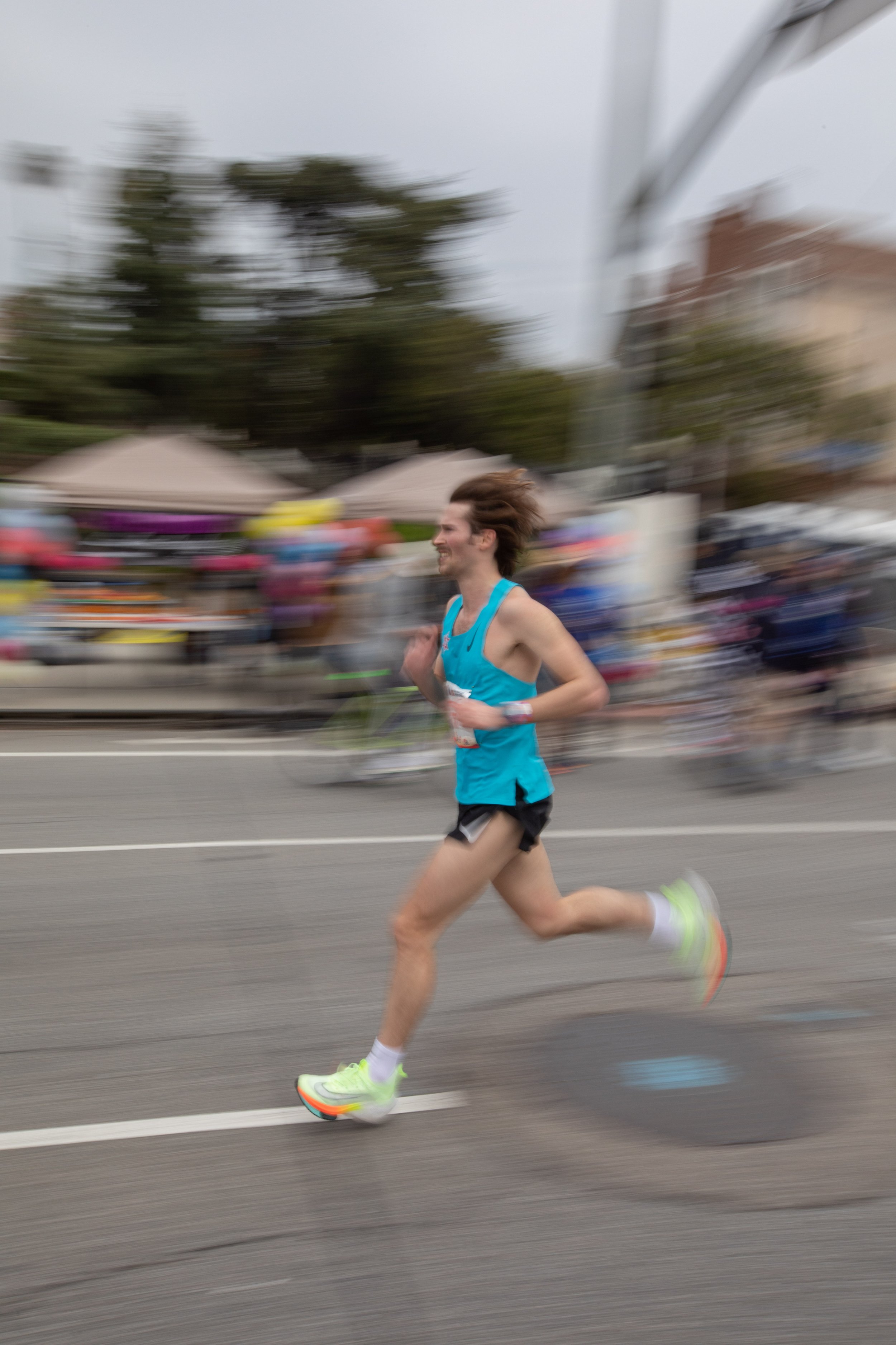  Marathon runner passes by mile 19 on Santa Monica Blvd. heading West. He crosses the colorful background of the Valley Runners Los Angeles cheering spot during the 38th Annual L.A. Marathon. Sunday, March 19, 2023. Los Angeles, Calif. (Jorge Devotto