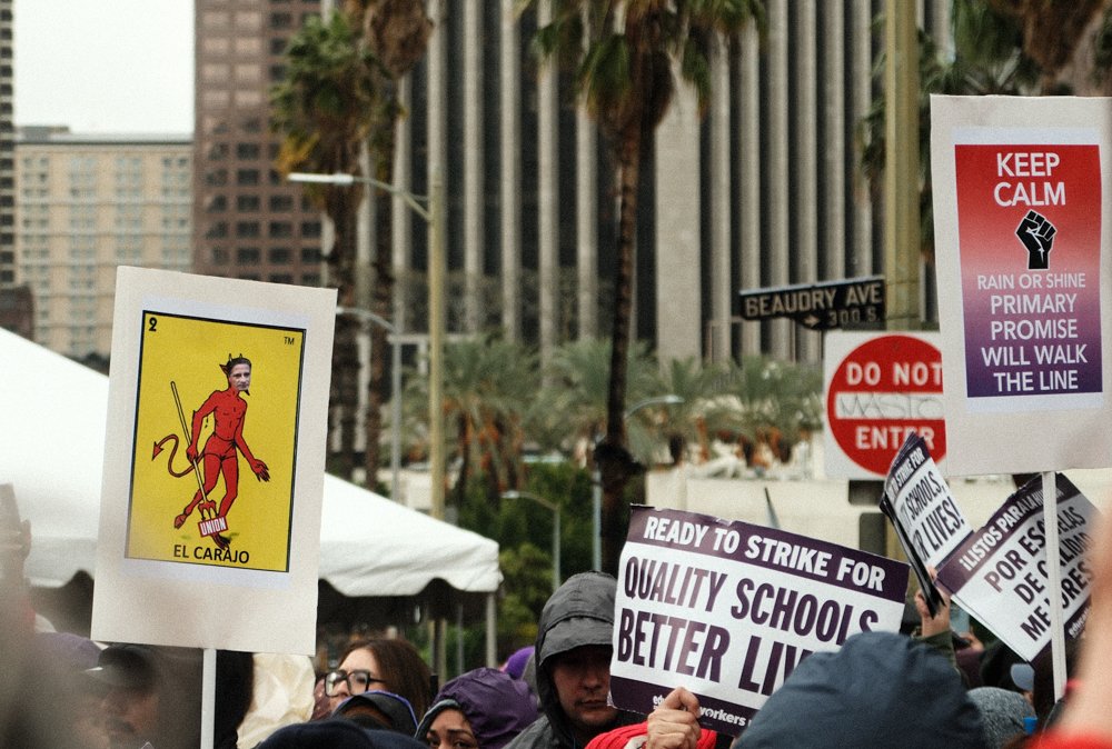  Attendee at the United Teachers Los Angeles(UTLA) rally holding up a sign of one of the cards from the famous bingo game "Loteria" , which was customized to show a Los Angeles Unified School District memeber with the name "El Carajo" on Tue. March 2