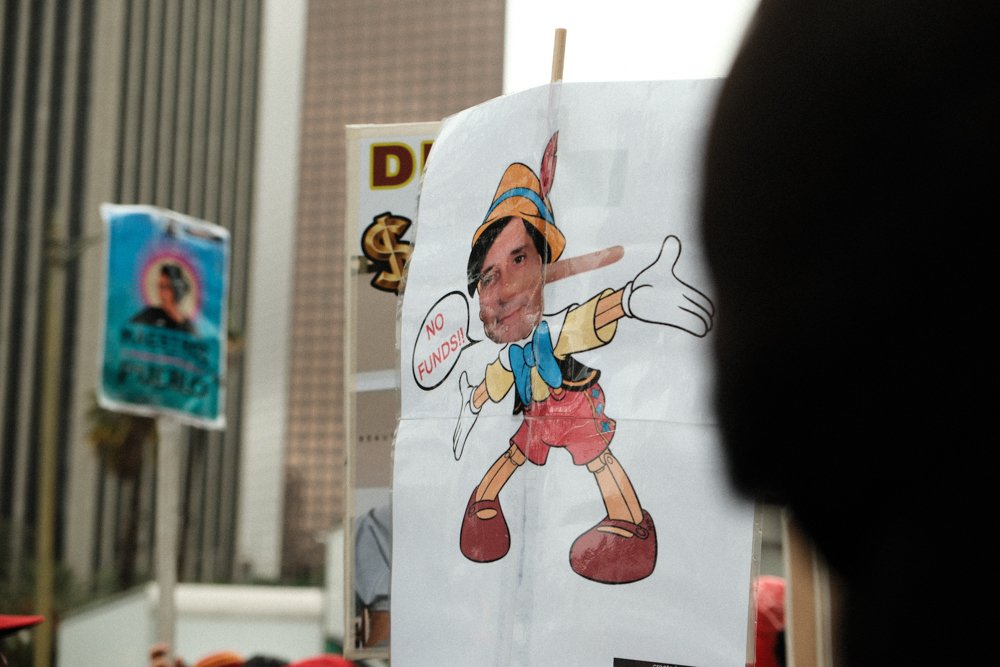  Attendee at the United Teachers Los Angeles(UTLA) rally holding up a sign of Pinochio which was photoshoped to have the face of a Los Angeles Unified School District memeber on Tue. March 21 at Los Angeles, Calif. (Danilo Perez | The Corsair) 