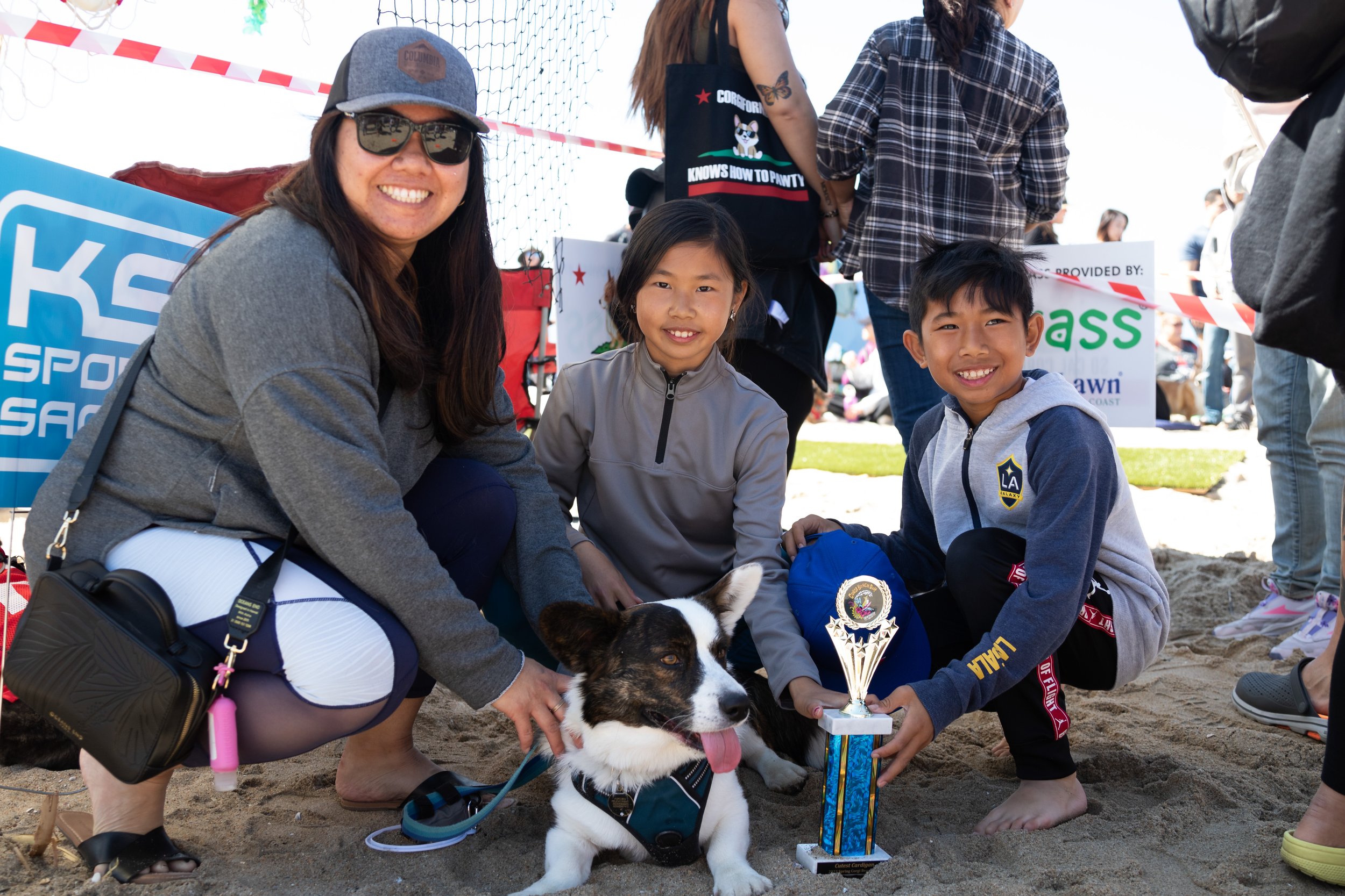  Christina Pruchyanimit (left), her children, and her dog, Popcorn, after winning the Cutest Corgi Cardigan Contest during Corgi Beach Day at Huntington Dog Beach, Huntington Beach, Calif., on Saturday, April 1, 2023. There were over a thousand peopl