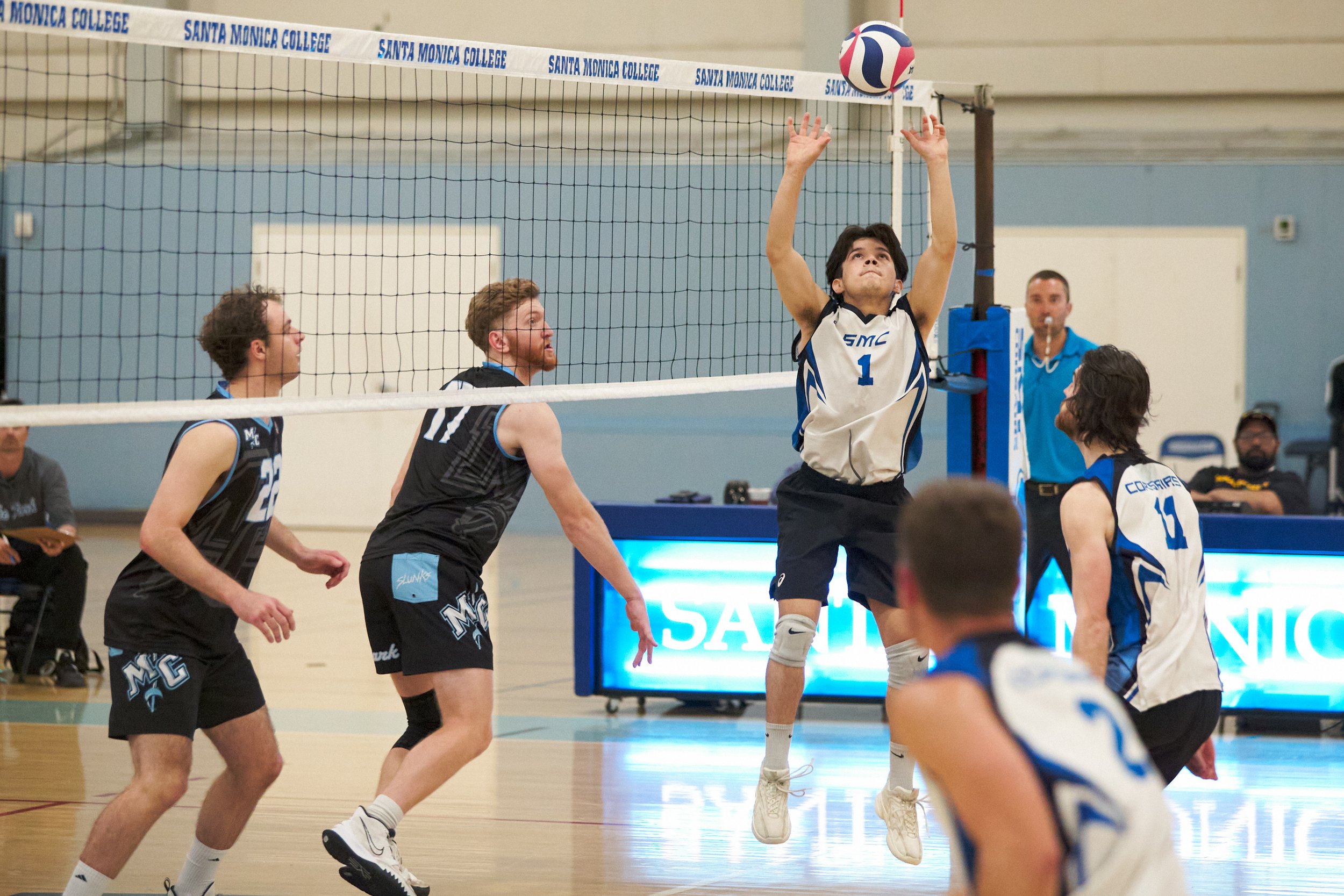  Santa Monica College Corsairs' Javier Barrientos (center) sets the ball during the men's volleyball match against the Moorpark College Raiders on Wednesday, April 12, 2023, at Corsair Gym in Santa Monica, Calif. The Corsairs lost 3-0. (Nicholas McCa