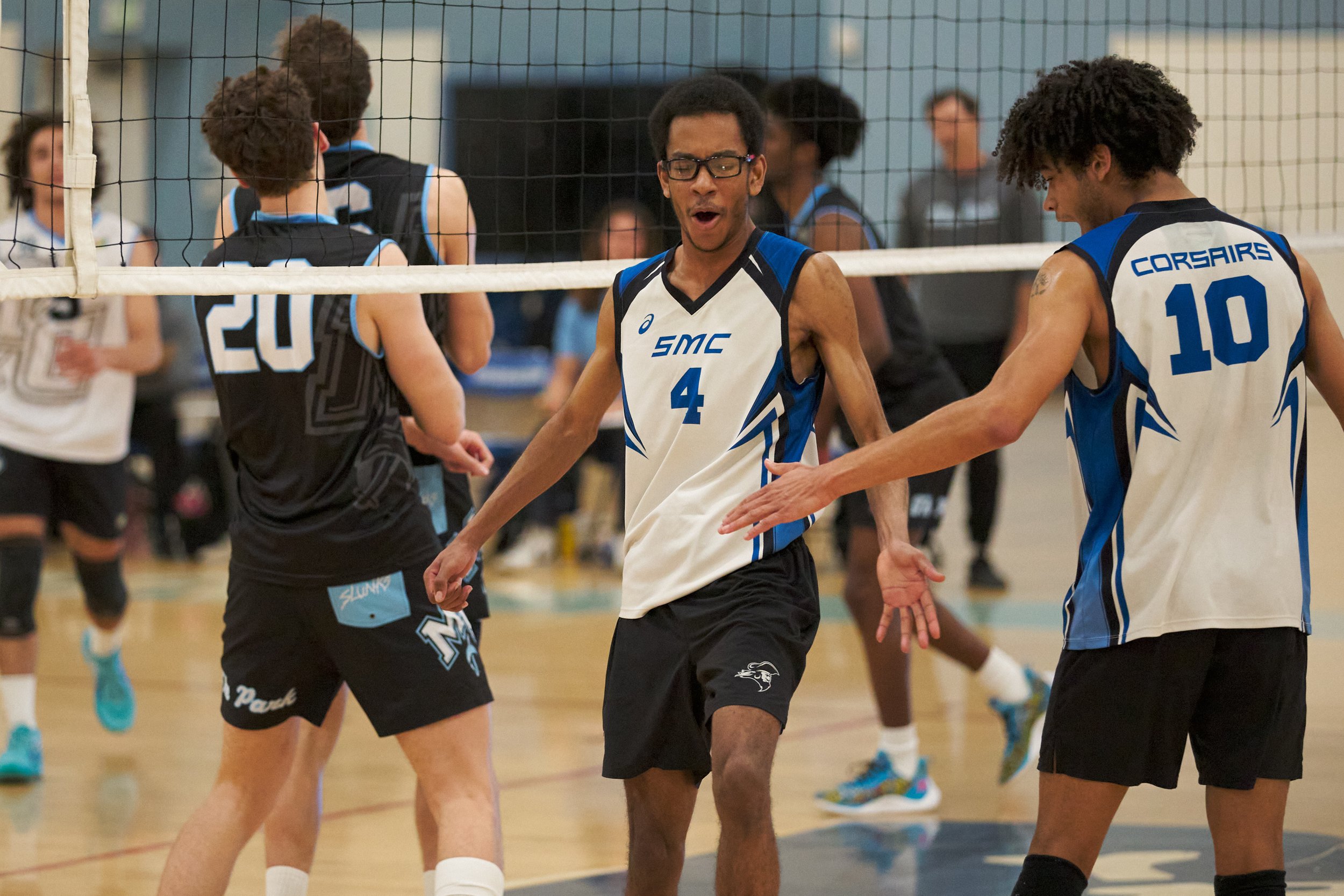  Santa Monica College Corsairs' Beikwaw Yankey (center) and Nate Davis (right) low-five after Yankey scored a kill during the men's volleyball match against the Moorpark College Raiders on Wednesday, April 12, 2023, at Corsair Gym in Santa Monica, Ca