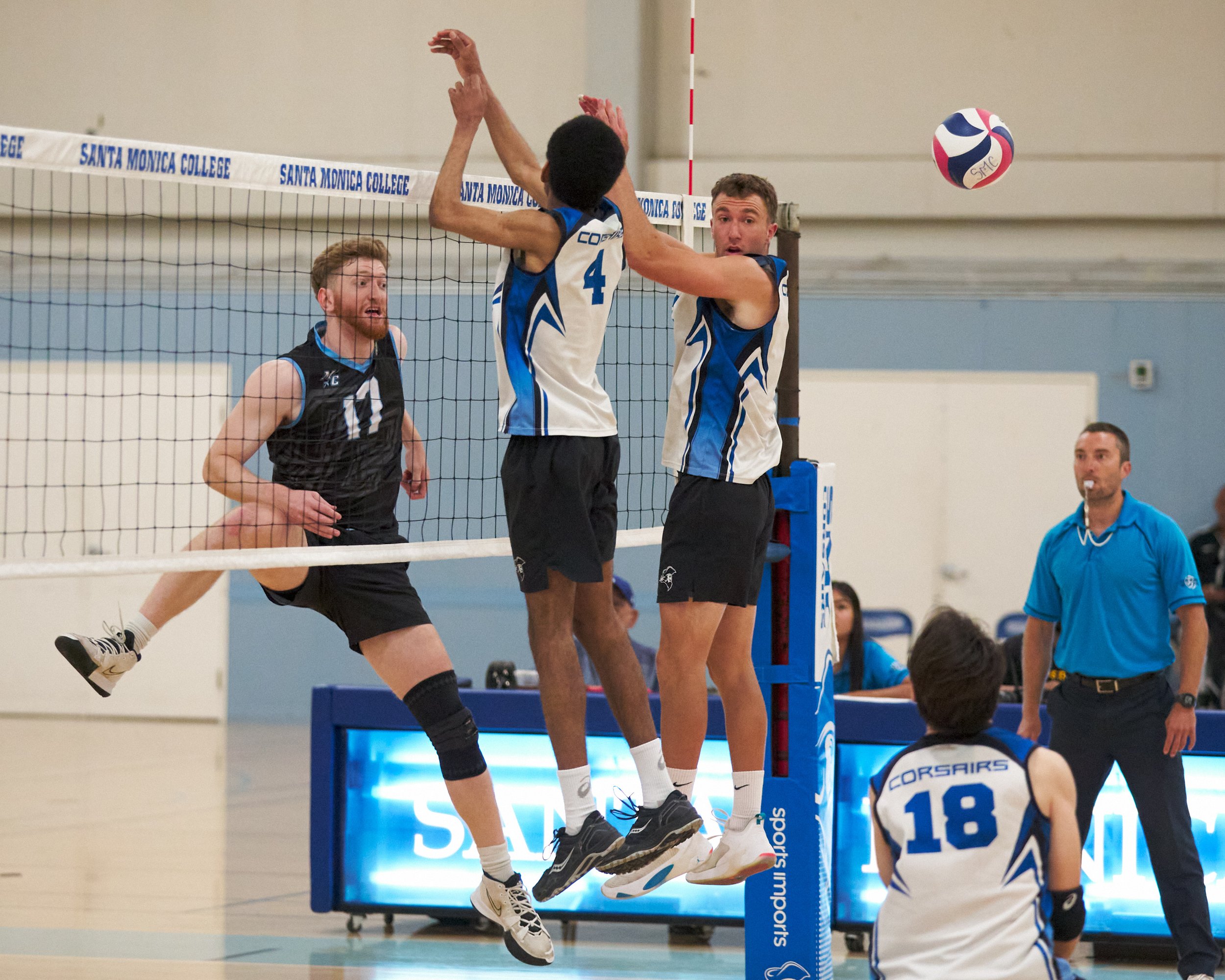  Moorpark College Raiders' Michael Stahl hits the ball past Santa Monica College Corsairs' Beikwaw Yankey and Kane Schwengel during the men's volleyball match on Wednesday, April 12, 2023, at Corsair Gym in Santa Monica, Calif. The Corsairs lost 3-0.