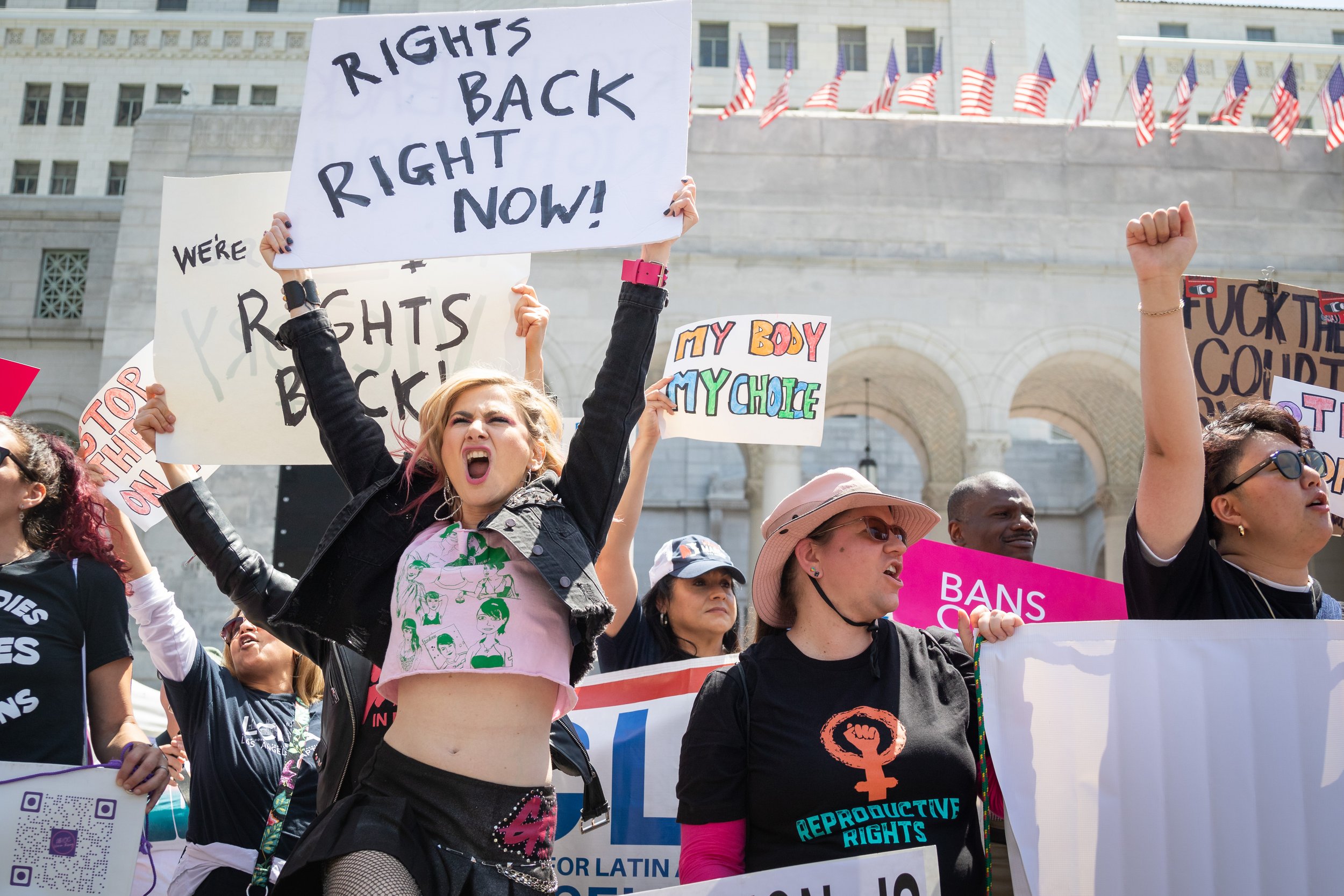  Shira Yevin (left), founder of Gritty in Pink, an organization that advocates for gender equity and equality in the music industry, holds a sign which reads "rights back, right now" during a protest organized by Women's March Foundation LA, Rise Up 