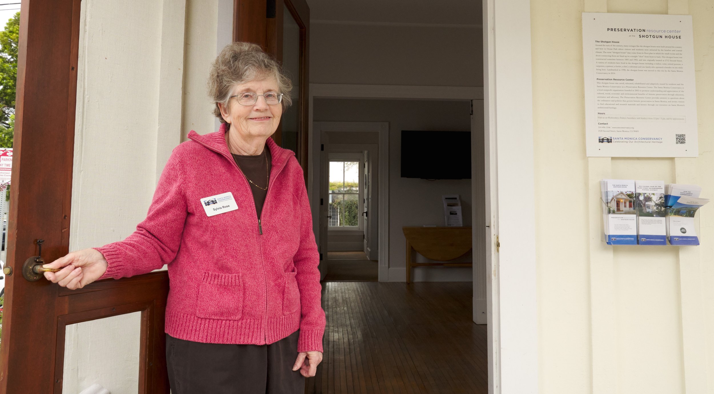  Santa Monica Conservancy Volunteer Docent Sylvia Rose holds the door open to the Preservation Resource Center at the Shotgun House on Wednesday, April 12, 2023, in Santa Monica, Calif. (Nicholas McCall | The Corsair) 