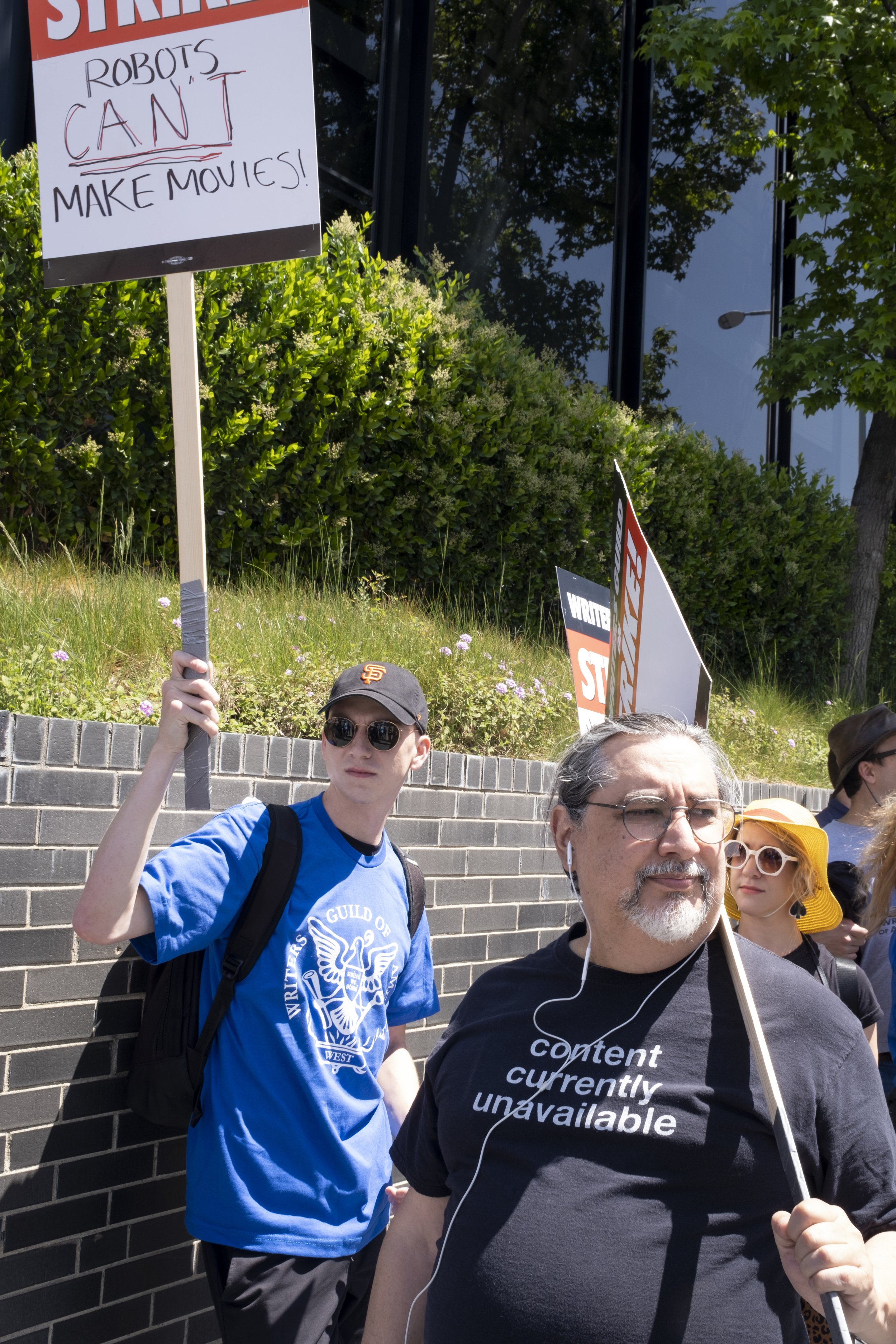  Writers Guild of America member Joey Koenig (left) pickets in front of Universal Studios in Studio City, Calif. on Tuesday, May 2 following disagreements within negotiations between the Alliance of Motion Pictures and Television Producers. (Anna Sop
