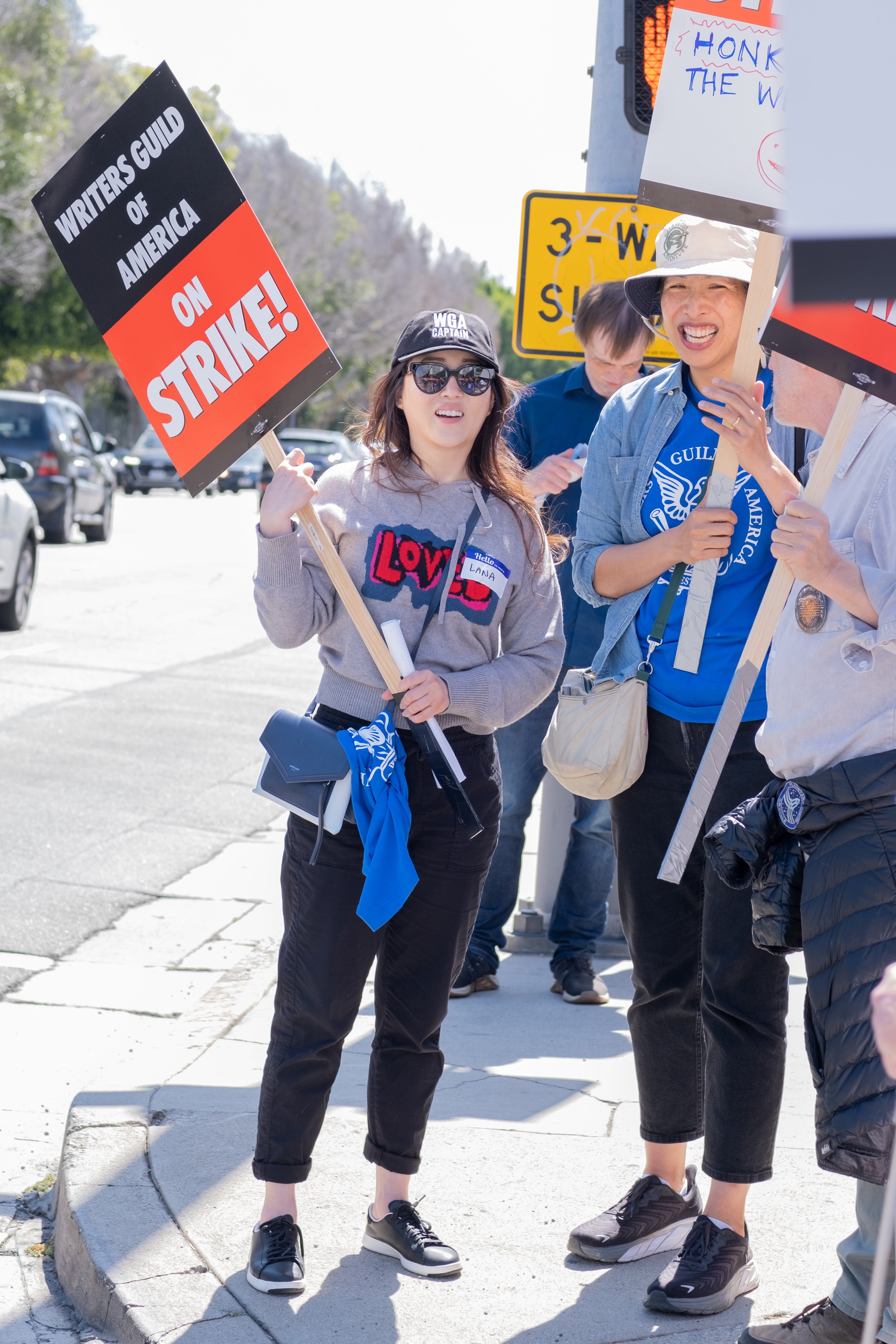  From L to R, Lana Cho and Janet Lin, friends who met in a writers' room participate in the protests in front of Fox Studios on Pico Blvd in Los Angeles, Calif. on Tuesday May 2nd, 2023. Lin states, "We're all having to piece together our careers now
