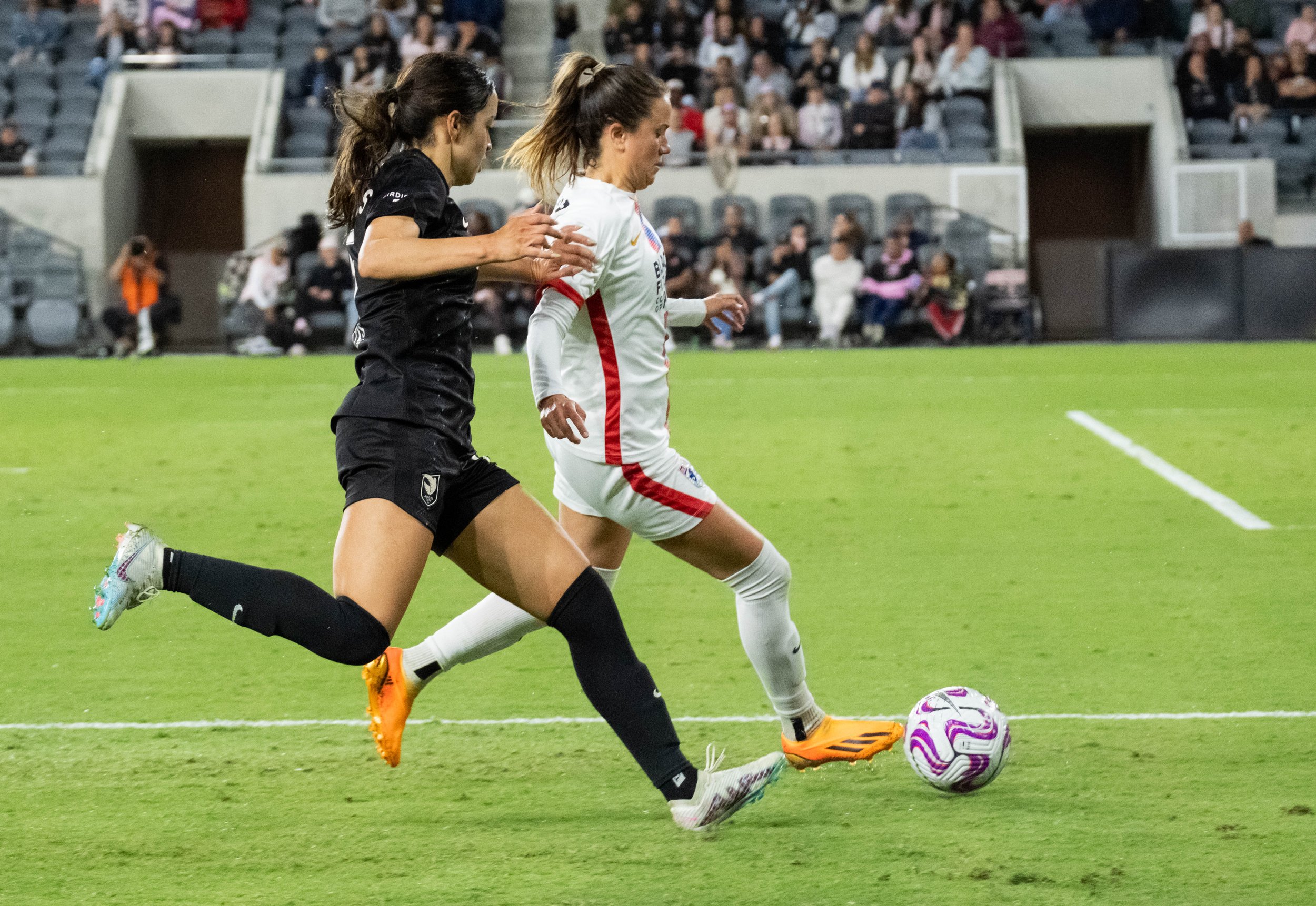  Angel City FC forward Scarlett Camberos(L) trying to take the ball away from OL Reign defender Lauren Barnes during their match on Wednesday, April 19, 2023 in BMO Stadium at Los Angeles, Calif. (Danilo Perez | The Corsair) 