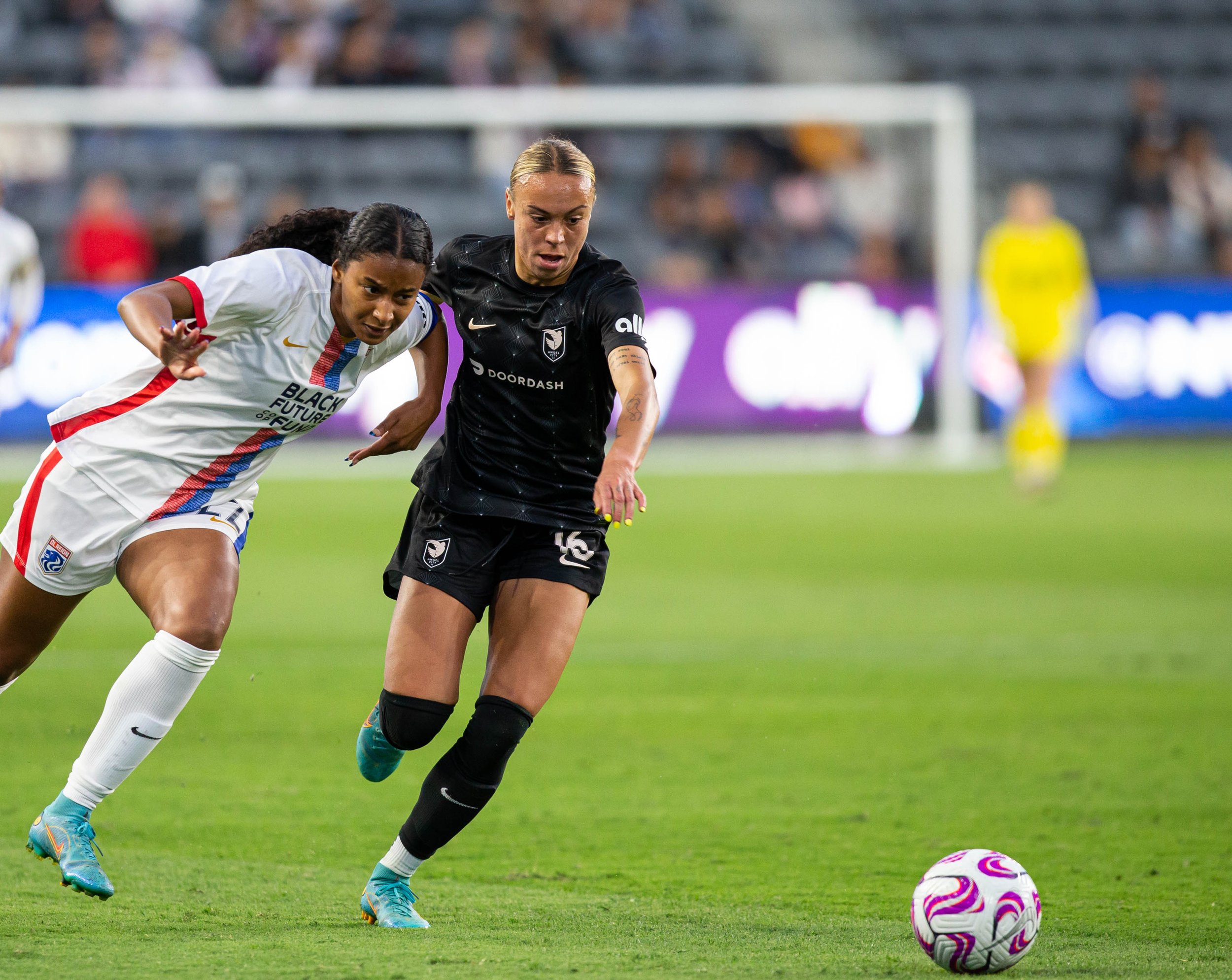  OL Reign forward Ryanne Brown(L) and Angel City FC defender Mary Alice Vignola(R) racing to the ball during their match on Wednesday, April 19, 2023 in BMO Stadium at Los Angeles, Calif. (Danilo Perez | The Corsair) 