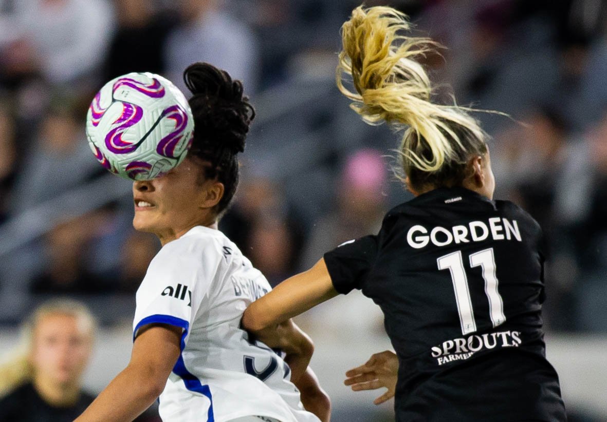  OL Reign forward Elyse Bennett(L) heading the ball away from Angel City FC defender Sarah Gorden(R) during their NWSL Challenge Cup match on Wednesday, April 19, 2023 in BMO Stadium at Los Angeles, Calif. (Danilo Perez | The Corsair) 