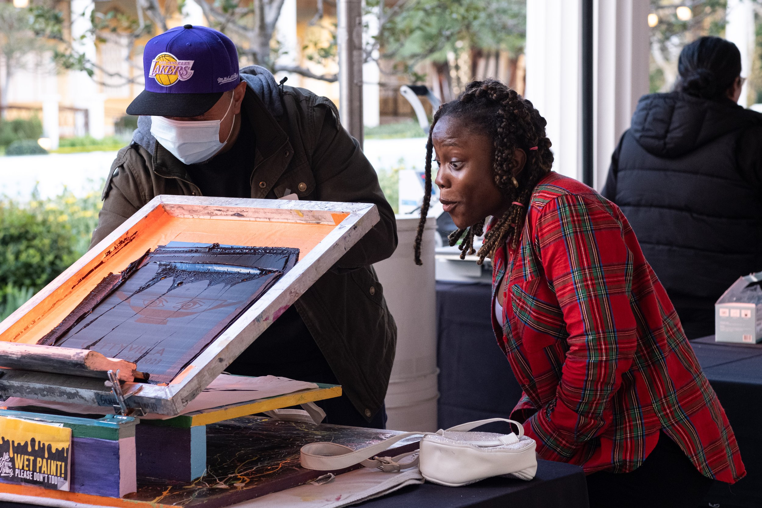  Daniella Pat-Onuoha, Biochemistry and Molecular Biology major at California Lutheran University gets to see the image she has just silk screened onto a tote bag at College Night on Wednesday, March 22, 2023. at the Getty Villa Museum in Pacific Pali