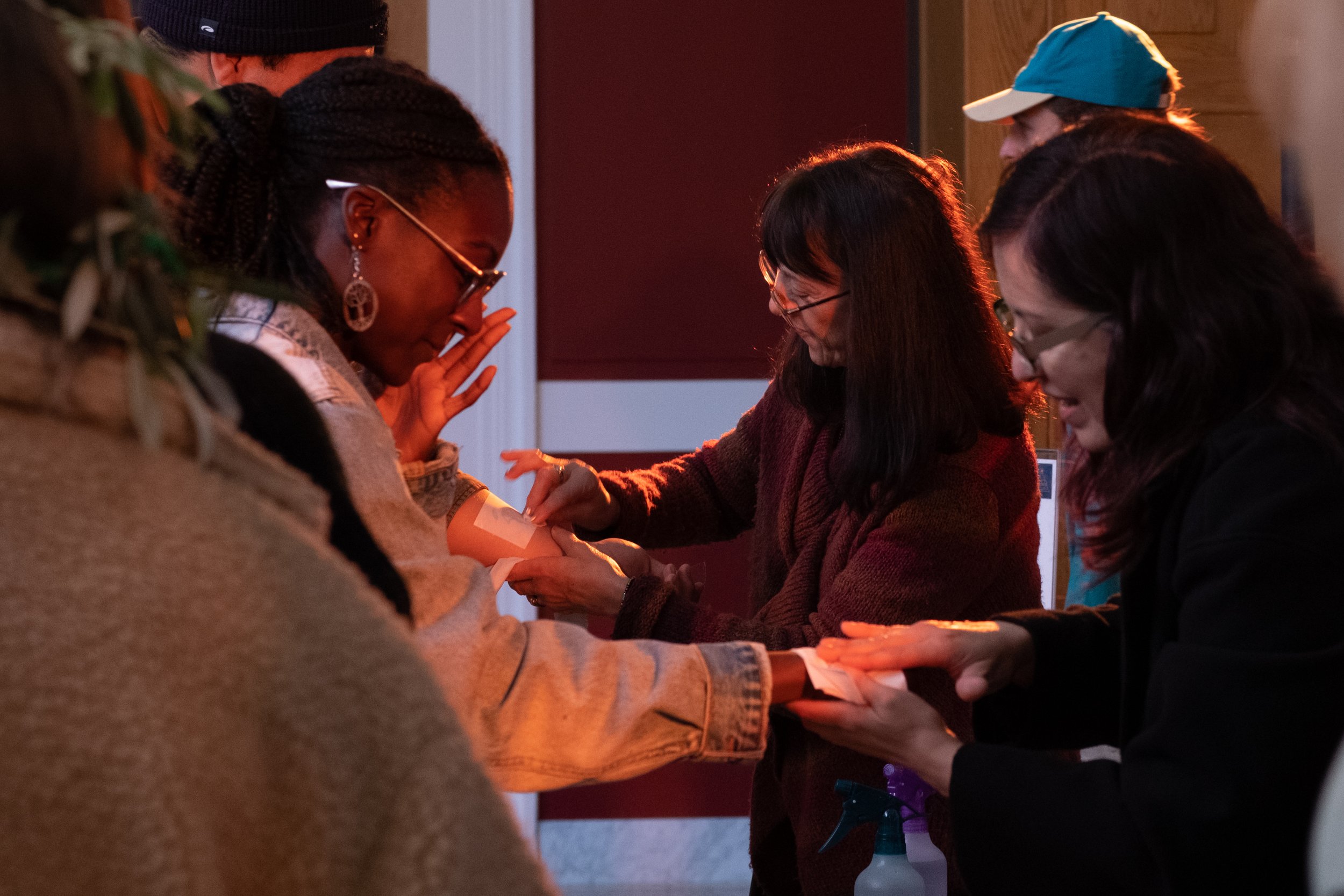  Staff at the Getty Villa Museum in Pacific Palisades, Calif. have prepared multiple activities for students to participate in at College Night on Wednesday, March 22, 2023. Students are getting temporary tattoos applied to their forearms. (Akemi Ric