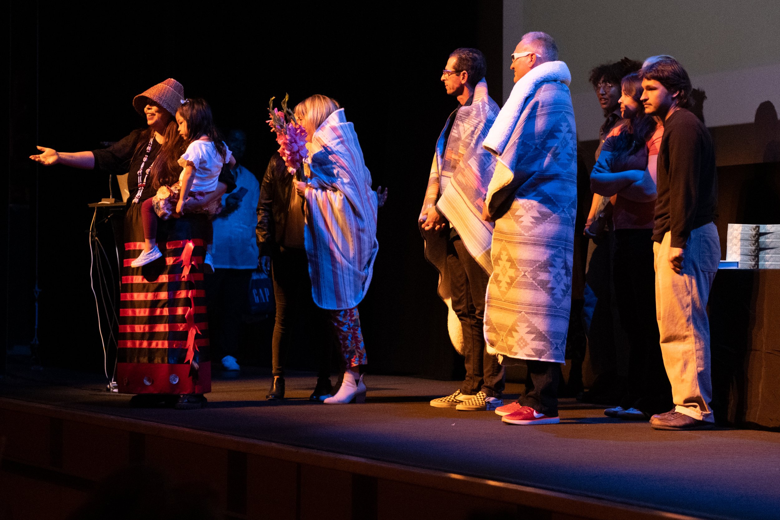  On Monday May 8th, 2023, Matika Wilbur, author of "Project 562, Changing The Way We See Native America", at the BroadStage Theater in Santa Monica, Calif., presents gifts of blankets to the faculty instrumental in making her experience at Santa Moni