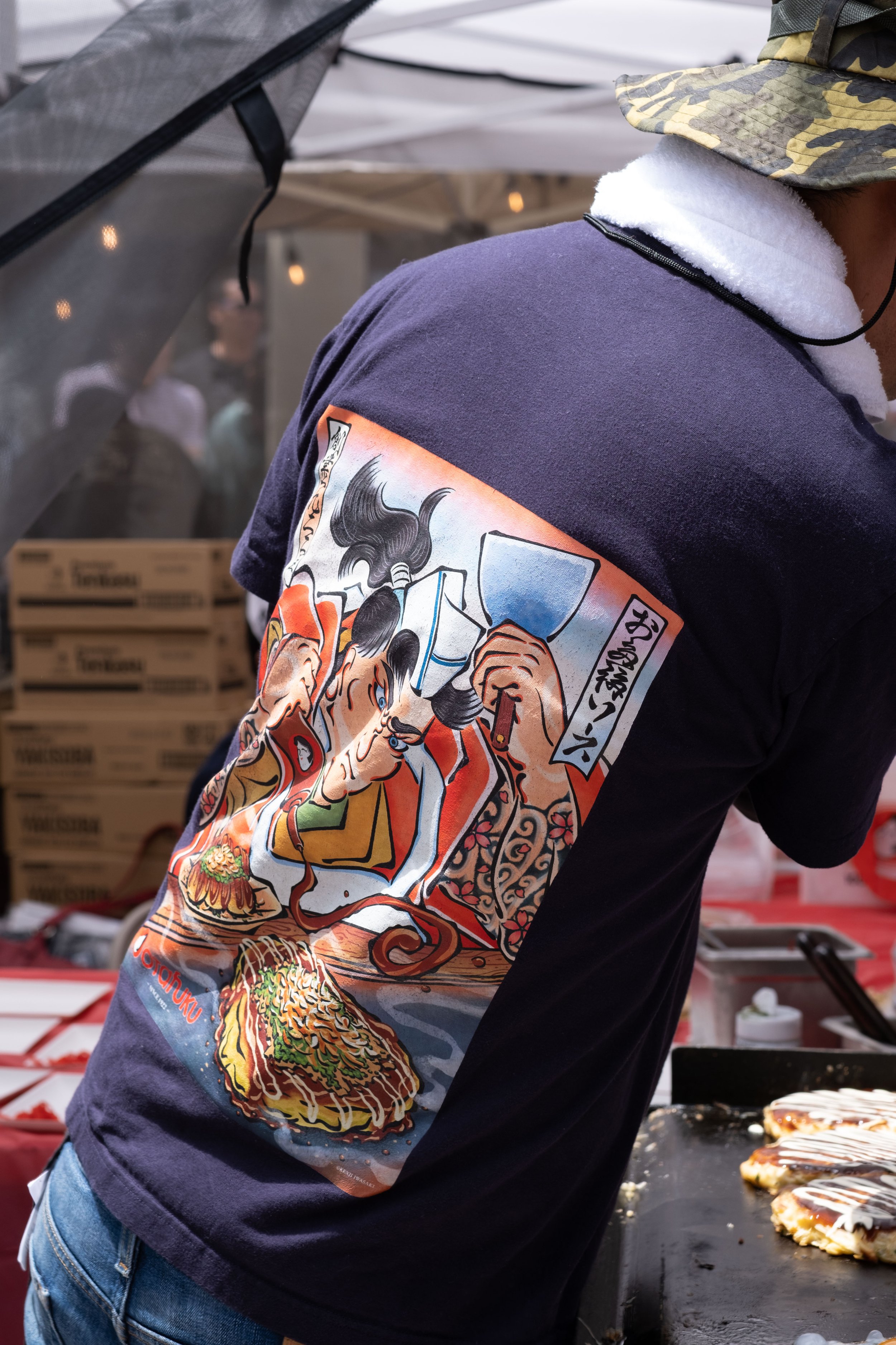  Food booths prepared many types of traditional Japanese food. Shown here on the back of a shirt is a picture of a man enjoying "okonomiyaki," a savory pancake, at the Torrance Cultural Arts Center in Torrance, Calif., at the Weekly LALALA 20th Anniv