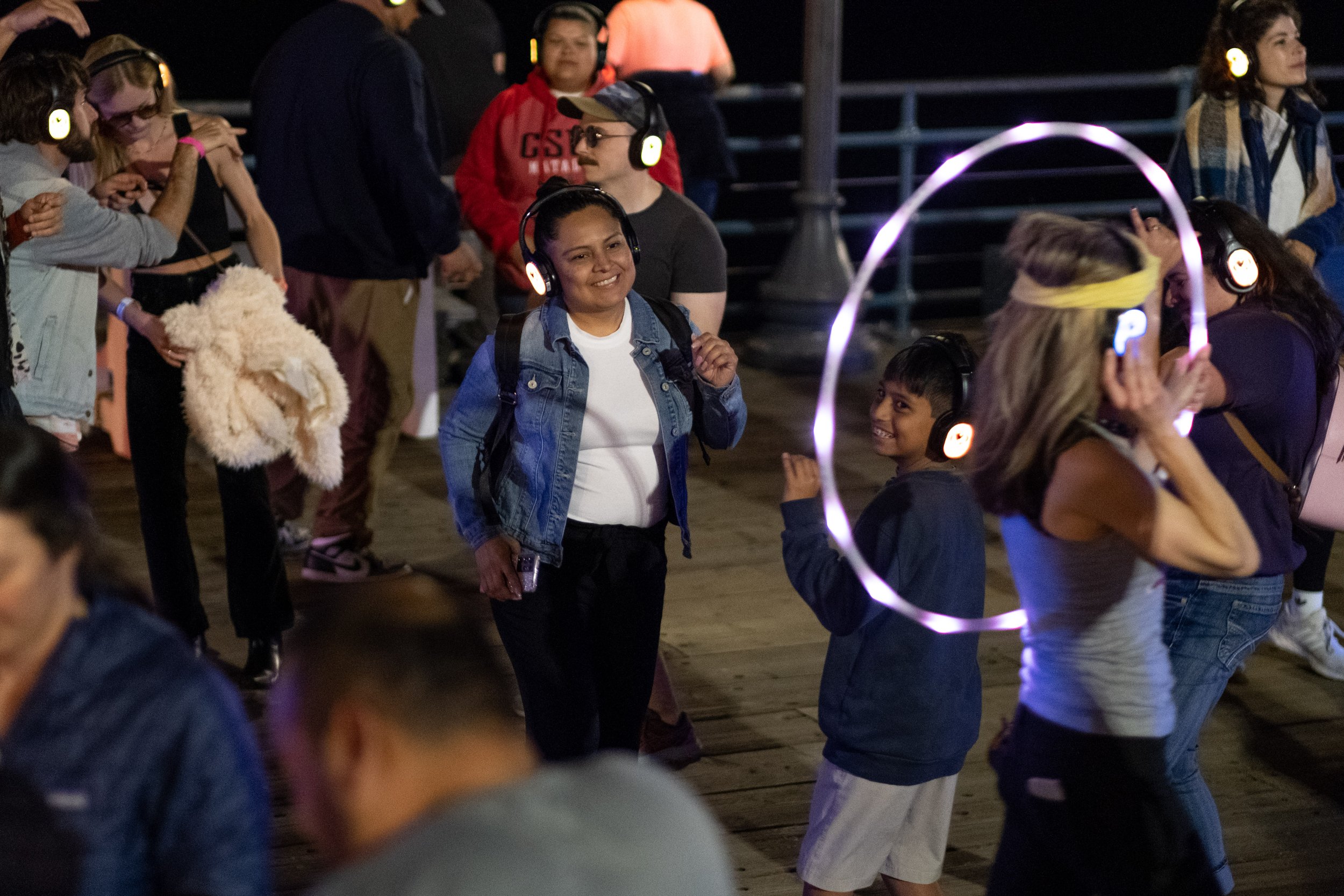  Dancers wore brightly lit up headphones to enjoy the Sunset Vibes Silent Disco at Locals' Night on Thursday, April 20, 2023 on the Santa Monica Pier at the West End of the pier in Santa Monica, Calif. The pier hosts Locals' Night every third Thursda
