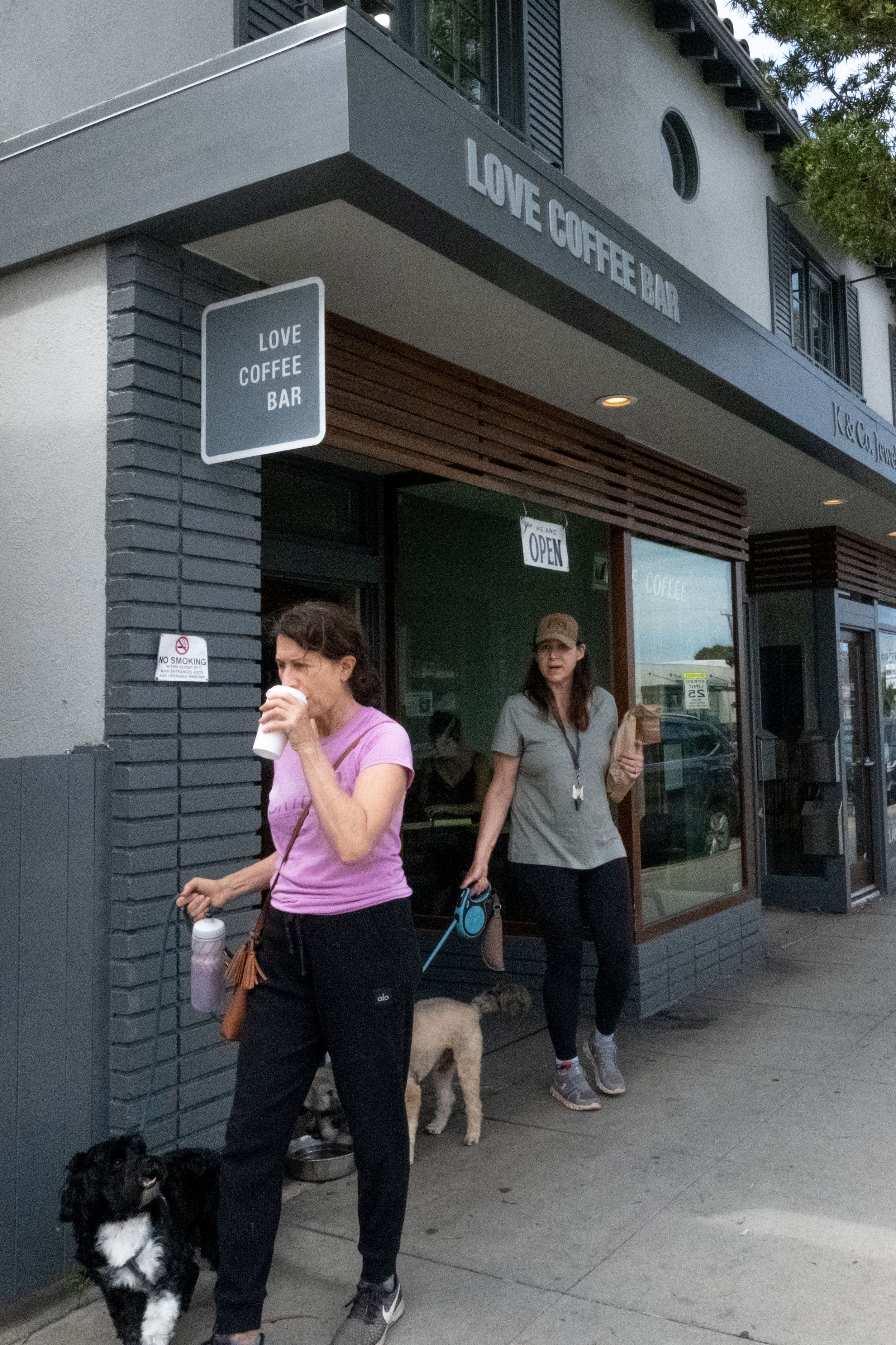  Patrons with their dogs exit the front entrance of Love Coffee Bar on Ocean Park Blvd. in Santa Monica, Calif. on Friday, May 26th, 2023. Love Coffee Bar is on Ocean Park Blvd. They offer an intriguing menu of artisanal signature drinks, with the op
