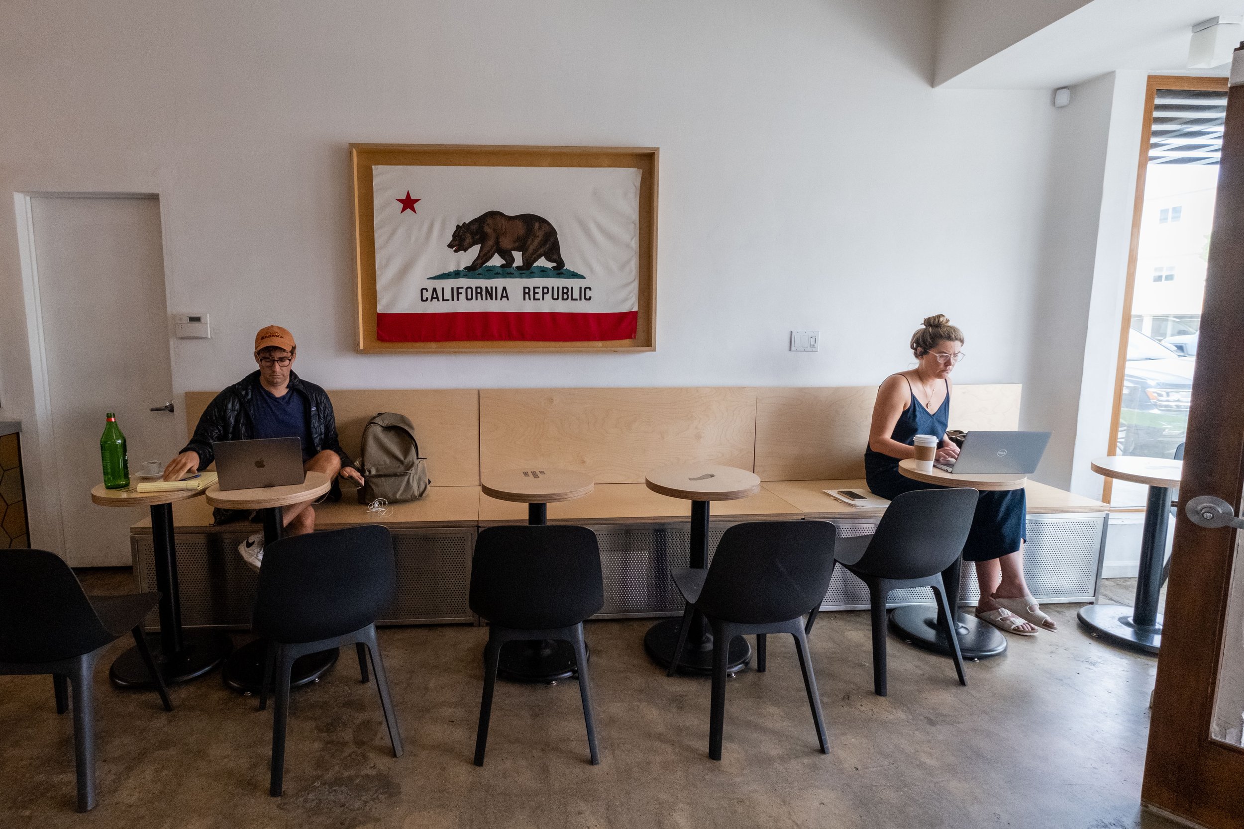  Patrons sit focused on their laptops inside Love Coffee Bar on Ocean Park Blvd. in Santa Monica, Calif. on Friday, May 26th, 2023. The coffee bar offers an intriguing menu of artisanal signature drinks, with the option to add a shot of CBD to any dr