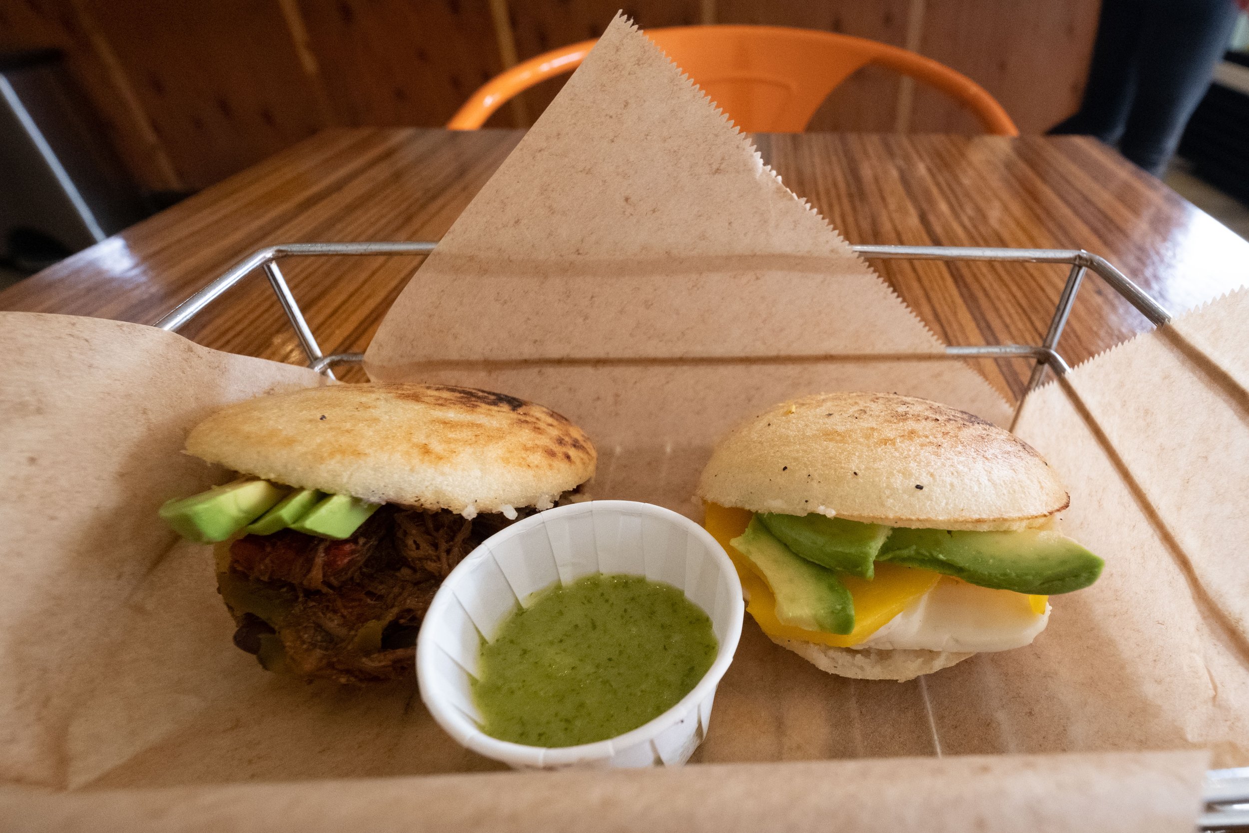  Shown here are Arepas, a Nicaraguan sandwich made to order with a cornmeal dough cut open for a flank steak filling (L) and mango, avocado and cheese (R), served with a chimichurri sauce. Bolivar Cafe is located on Ocean Park Blvd. and 18th St. In a