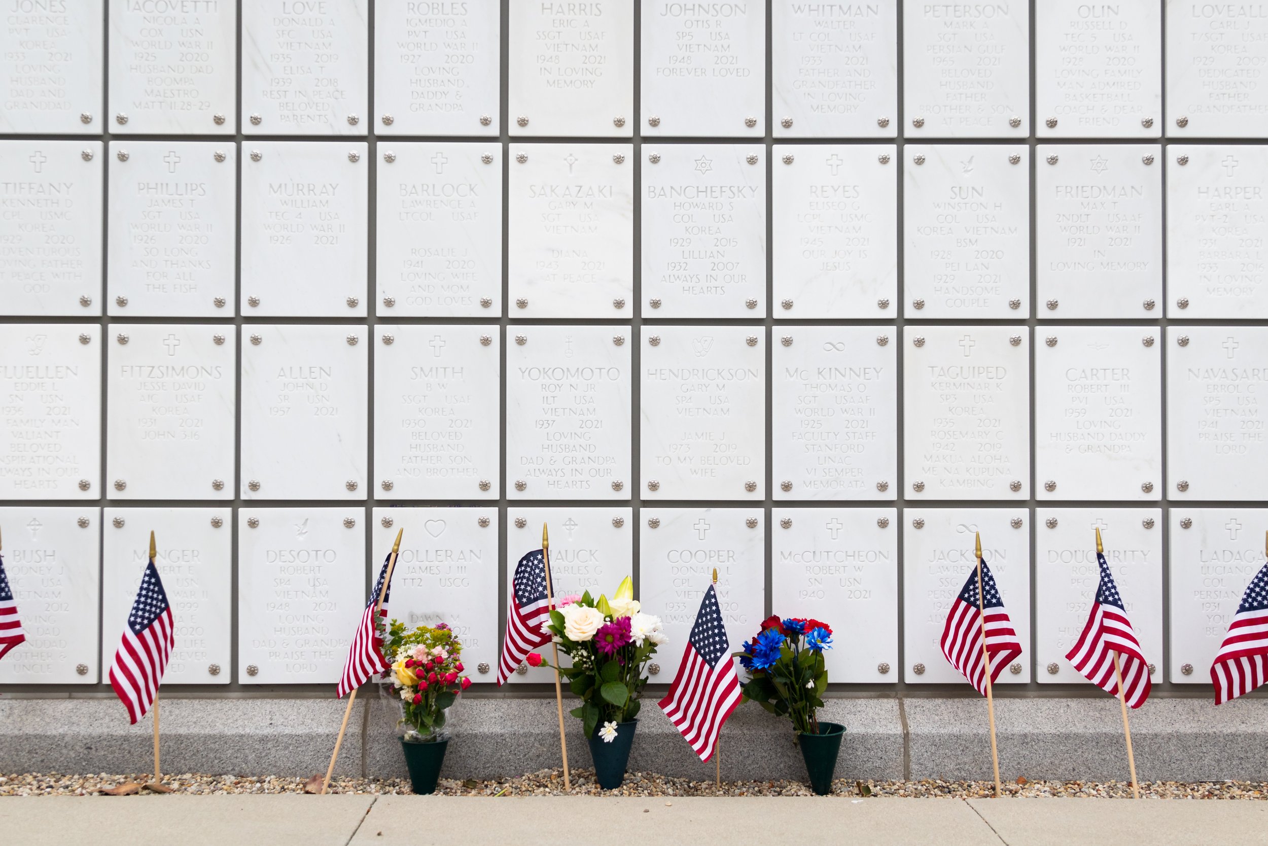  Flowers and flags sit in front of graves for a Memorial Day Celebration at Los Angeles National Cemetery, Los Angeles, Calif., on Monday, May 29, 2023. (Caylo Seals | The Corsair) 