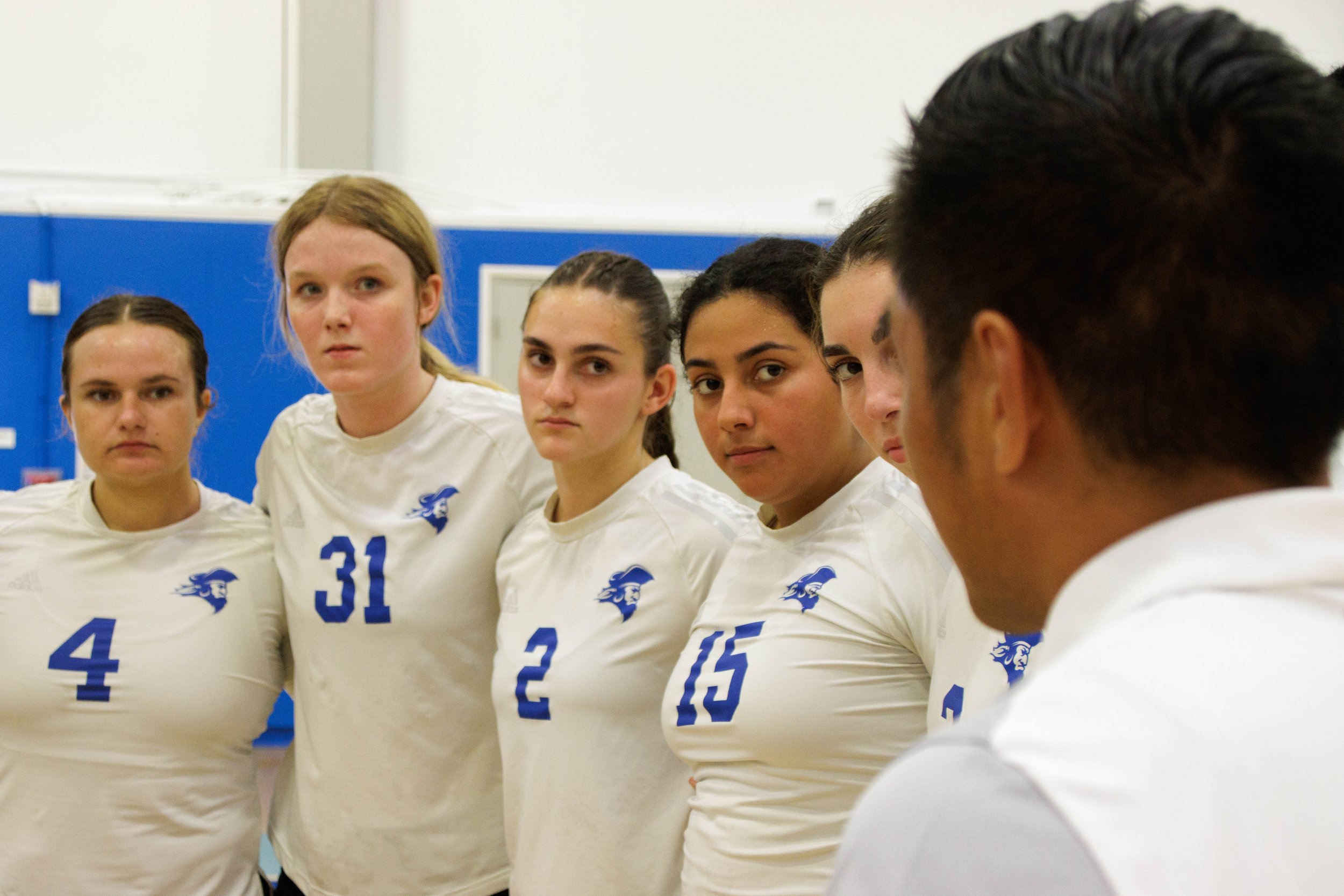  Team members of Santa Monica College (SMC) Women's Volleyball gather around their coach, Christian Cammayo, right,  during a match against San Diego Miramar at the SMC gymnasium, Santa Monica, Calif. on Sept. 08, 2023. They are gathered around to di