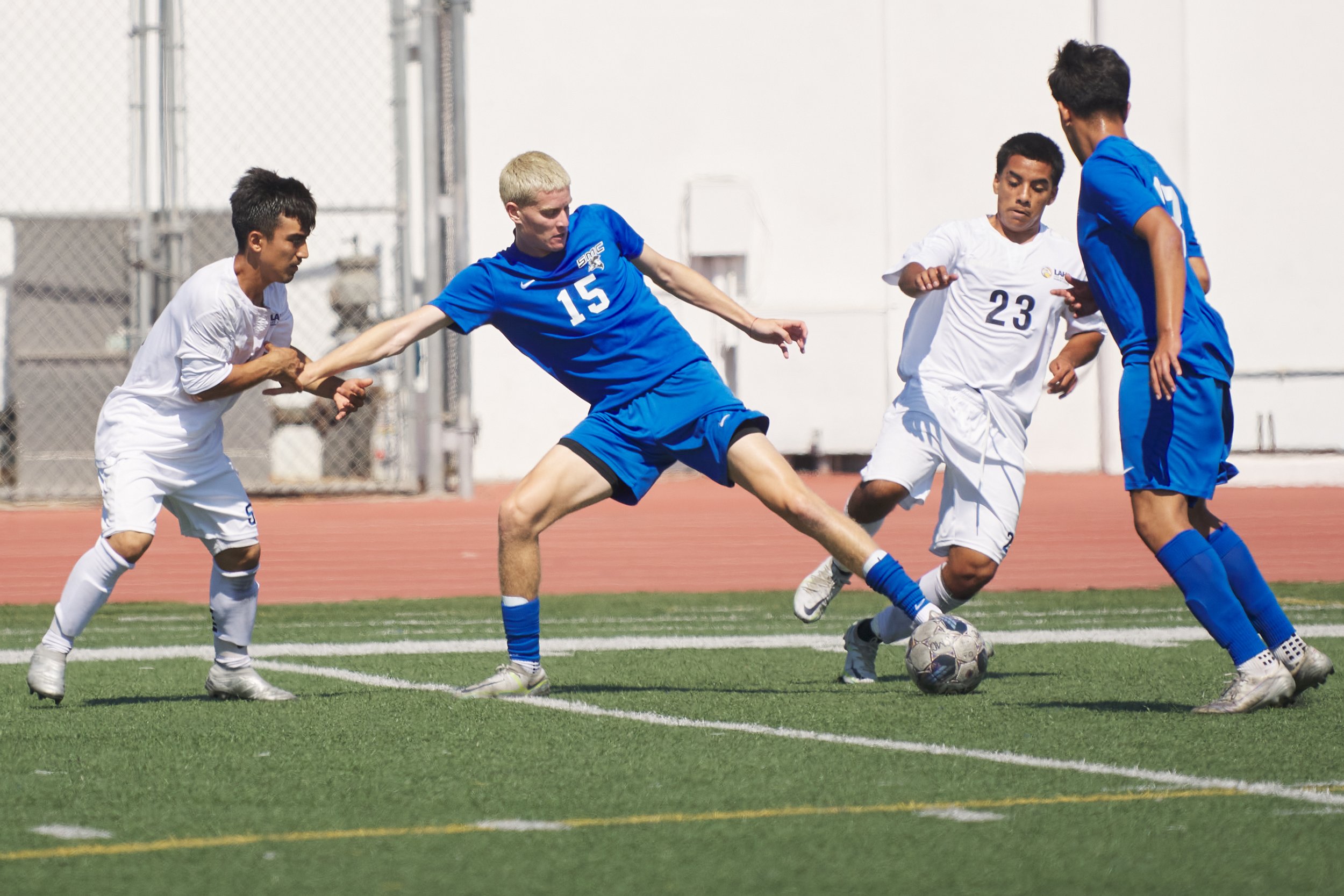  Santa Monica College Corsairs' Edan Lazarovich (center) kicks the ball away from Los Angeles Harbor College Seahawks' Tommy Murillo (left) and Isaac Niebla (23) during the men's soccer match on Friday, Sept. 9, 2023, at Corsair Field in Santa Monica