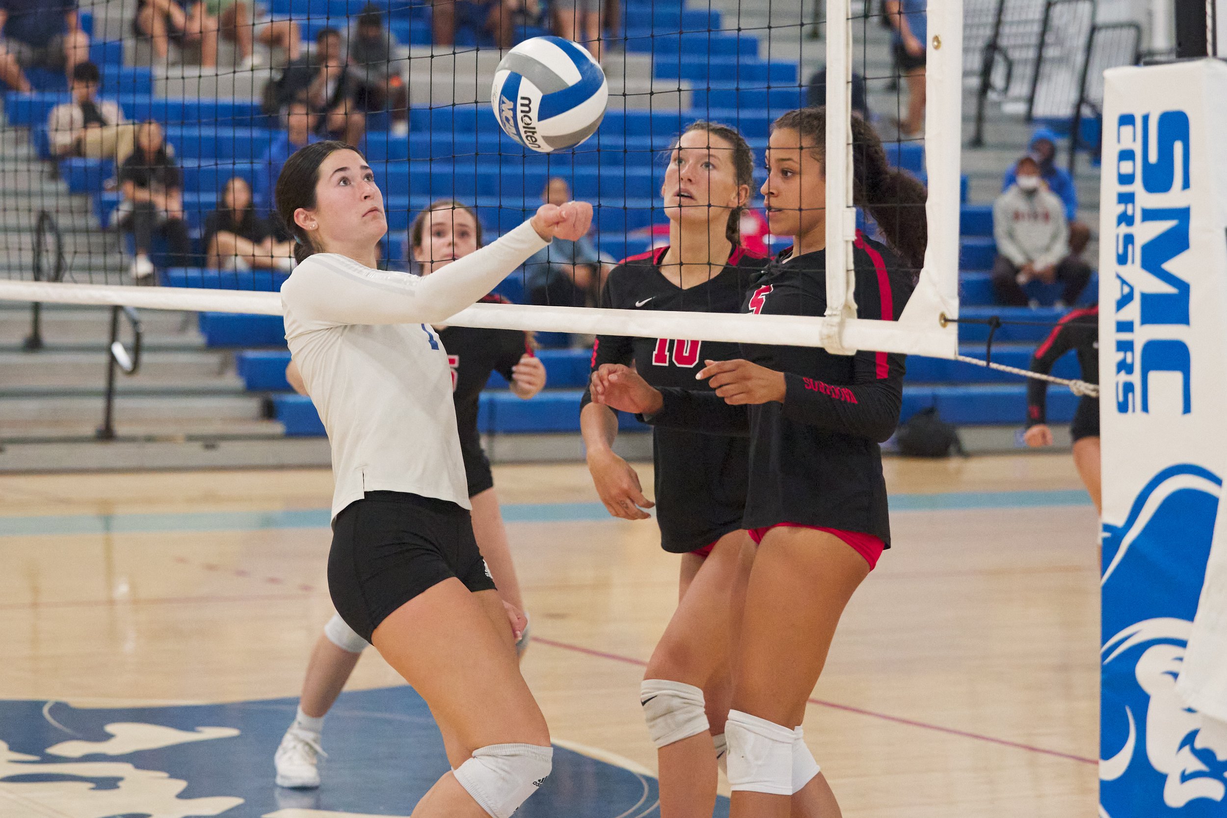  Santa Monica College Corsairs' Maiella Riva hits the ball across from Santa Barbara City College Vaqueros' Alexis Zevenbergen and Nevaeh Tillet during the women's volleyball match on Wednesday, Sept. 20, 2023, at Corsair Gym in Santa Monica, Calif. 