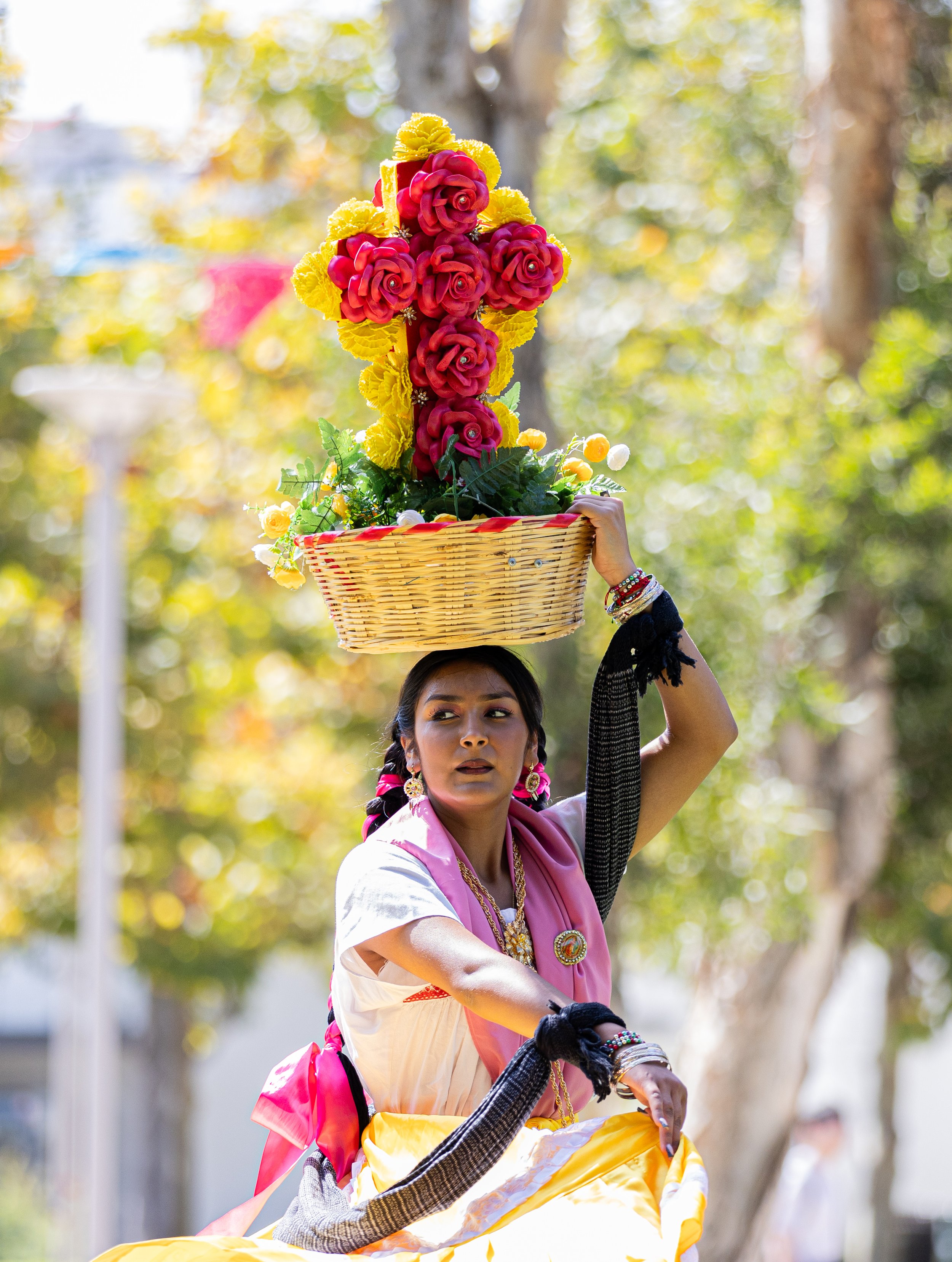  Oaxacena holding a basket filled with flowers and a cross arranged flower over their head during la Jarabe del Valle in the Guelaguetza event and first Oaxacan event held in Santa Monica College's quad on Thu. Spet. 28 at Santa Monica, Calif. (Danil