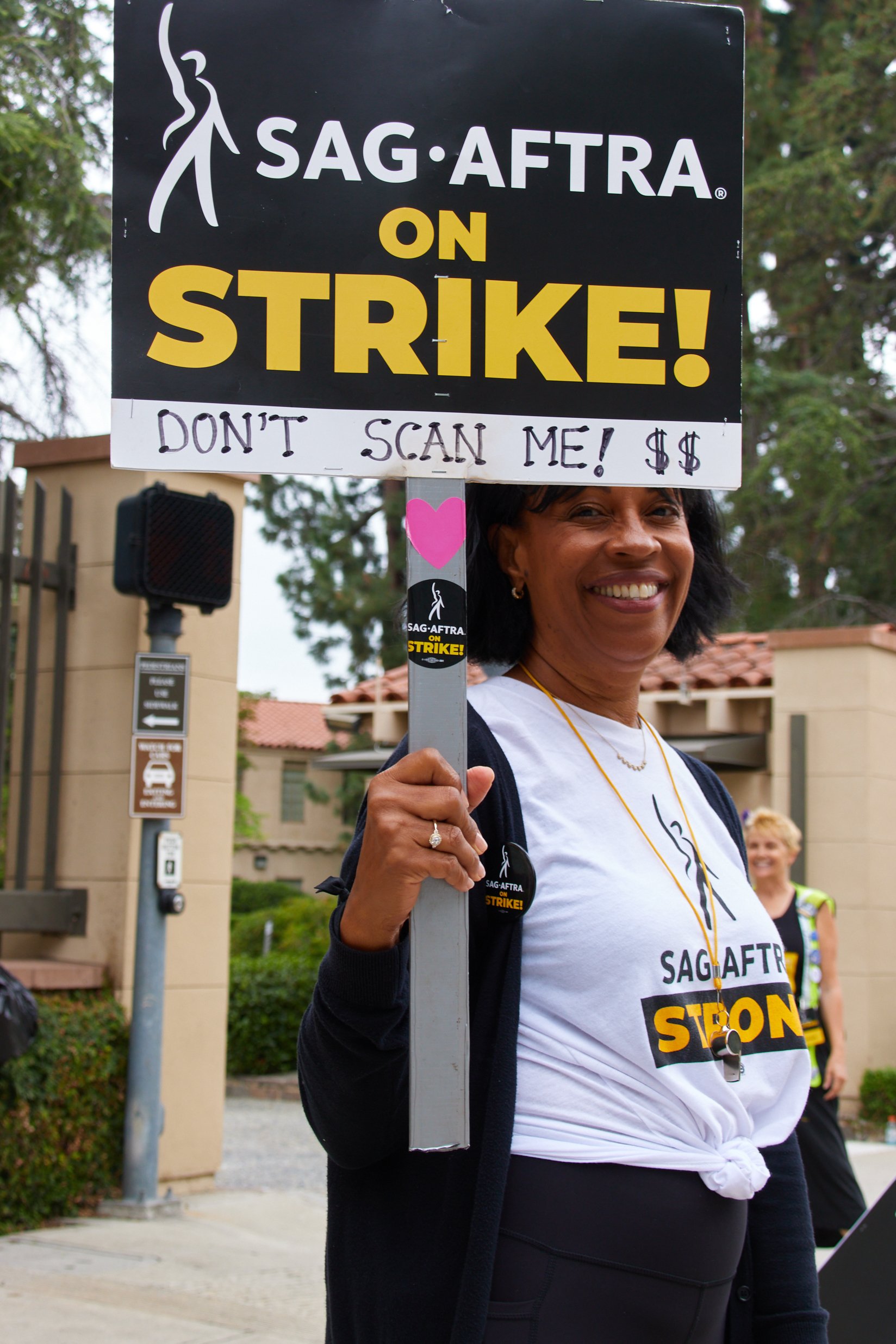  Actress and SAG-AFTRA member Melvina Strikes poses with a picket sign with "DON'T SCAN ME! $$" written on it during the SAG-AFTRA strikes in front of Warner Bros. Studios, Burbank, Calif., on Sept 29, 2023. She had played a background character in t