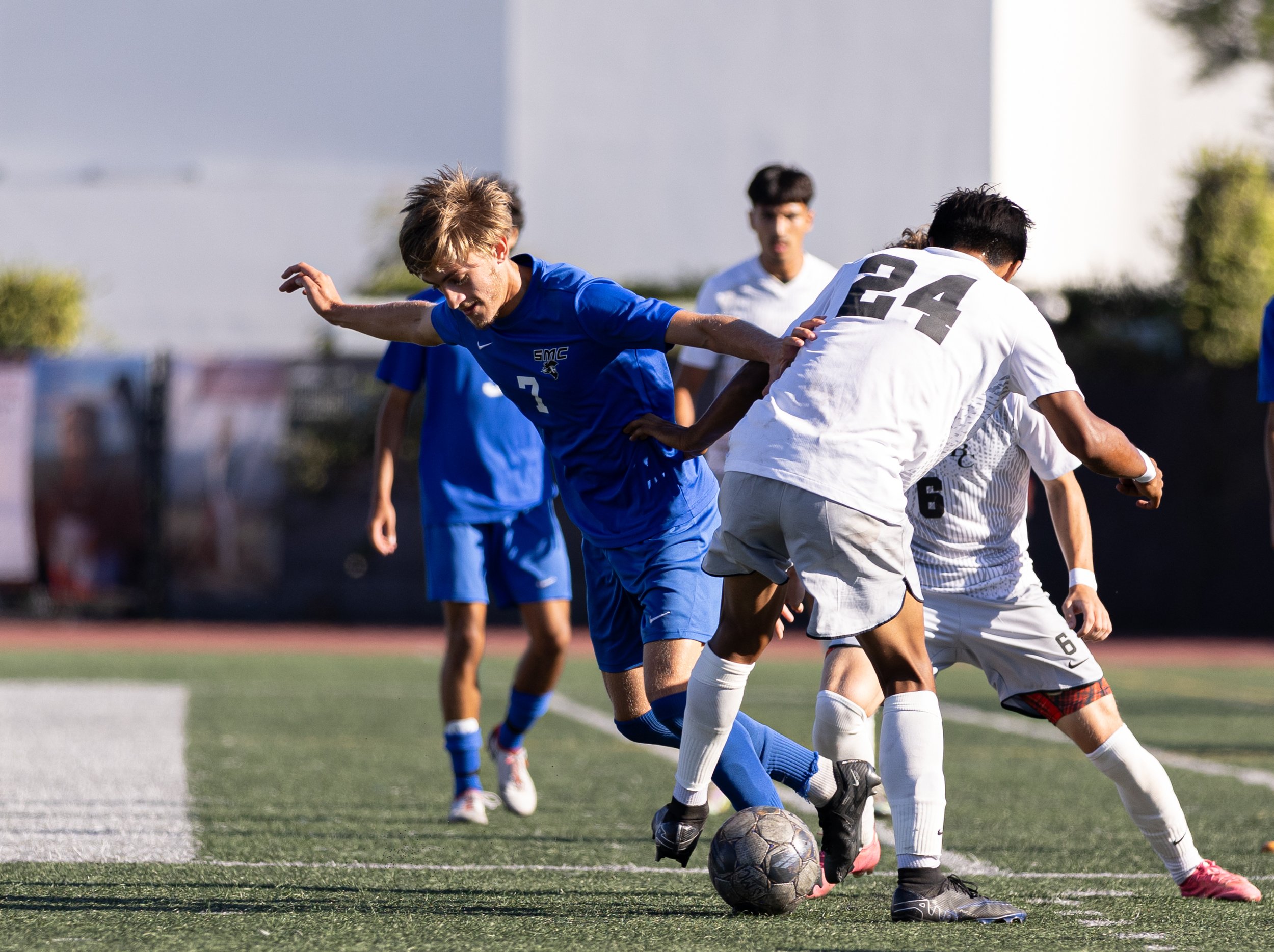  Santa Monica College(SMC) men's soccer forward Darren Lewis(7) being pocketed by Bakersfield Renegade defender Joe Estrada(24) on Tues, Oct. 3. SMC would go and shutout the Renegades with a score of 3-0 at Corsair Field in Santa Monica, Calif. (Dani