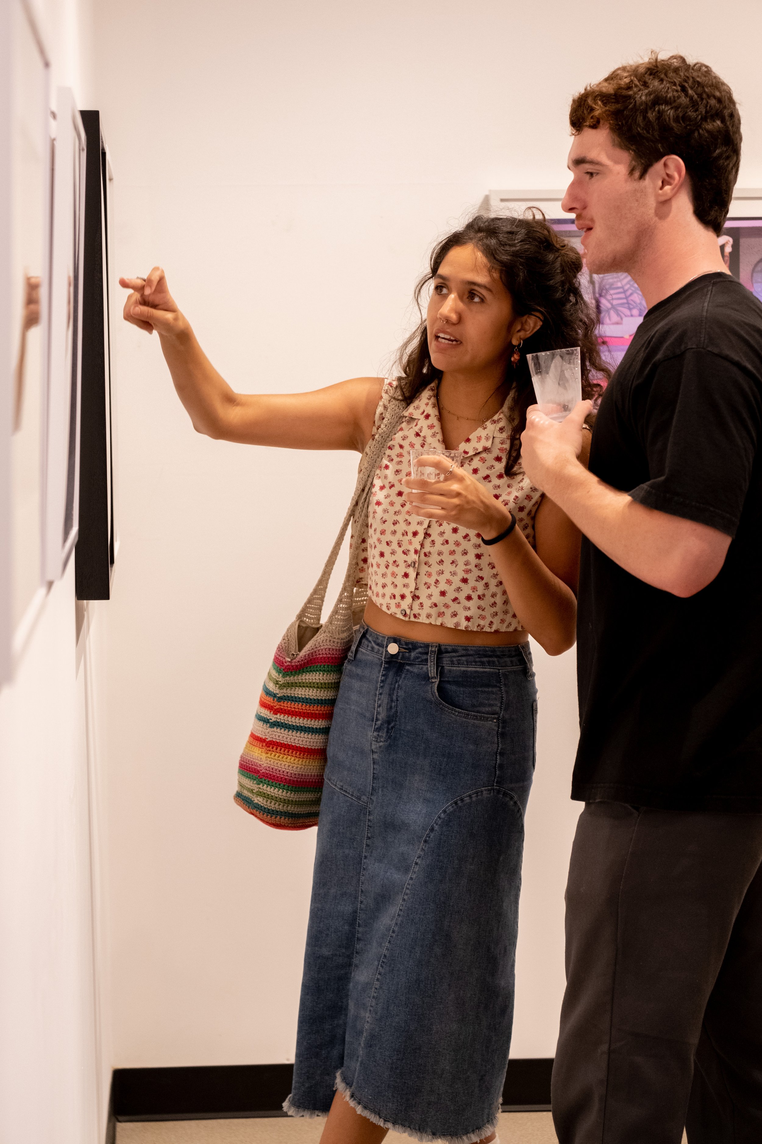  Art major Madison Singleton and her boyfriend Jack Simon observing the photos displayed in Drescher Hall, 2nd floor, at the Santa Monica College main campus in Santa Monica, Calif. at the opening reception of the annual Faculty & Staff Exhibition an