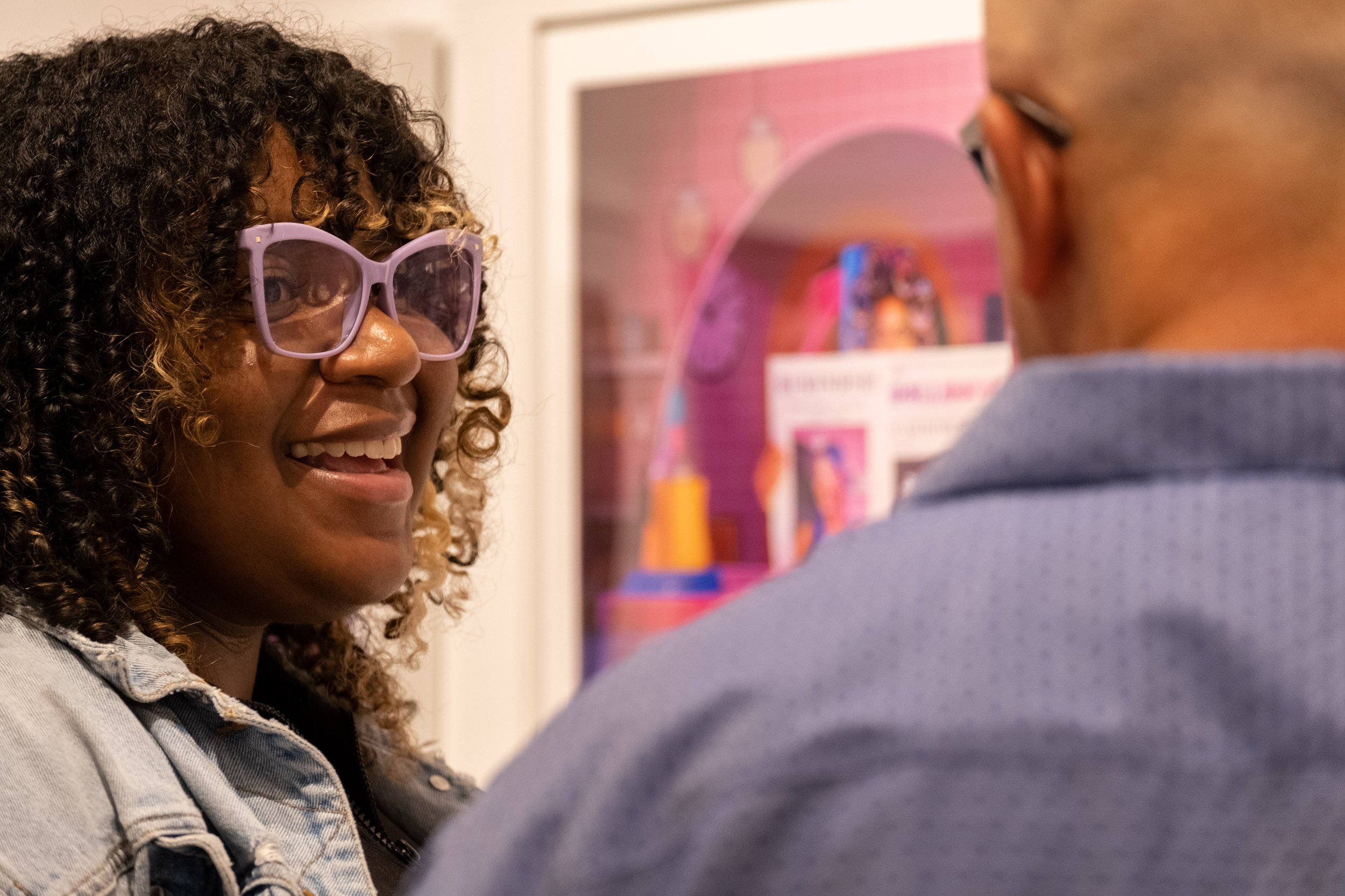  Stephanie Price, digital lab technician, chats with photography student Robert while standing in front of her work displayed in Drescher Hall, 2nd floor, at the Santa Monica College main campus in Santa Monica, Calif. at the opening reception of the