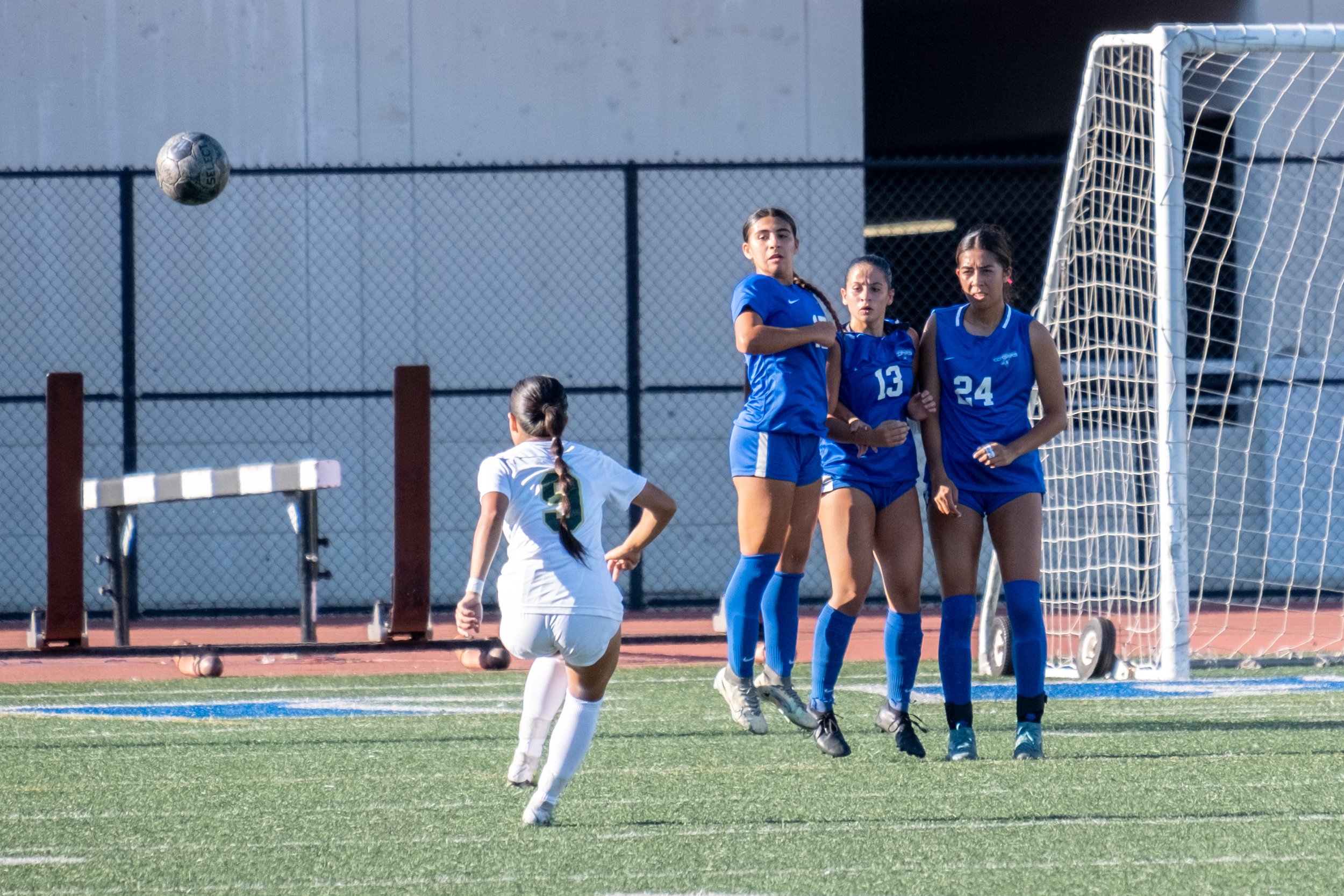  LA Valley College Monarchs Phoenix Becerra (left) kicks a penalty kick as Santa Monica College Corsairs' (in blue, from left to right) Alinna Savaterre, Lia Agapitos and Andrea Ortiz during the women's soccer match on Friday, Oct. 6, 2023 at Corsair